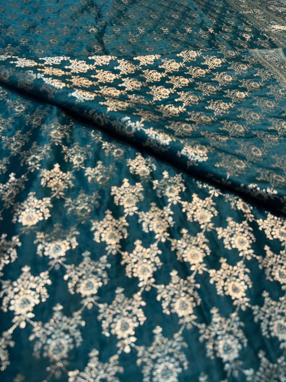 Elegant Banarasi saree with intricate gold patterns and matching unstitched blouse, traditional Indian cultural wear for women.