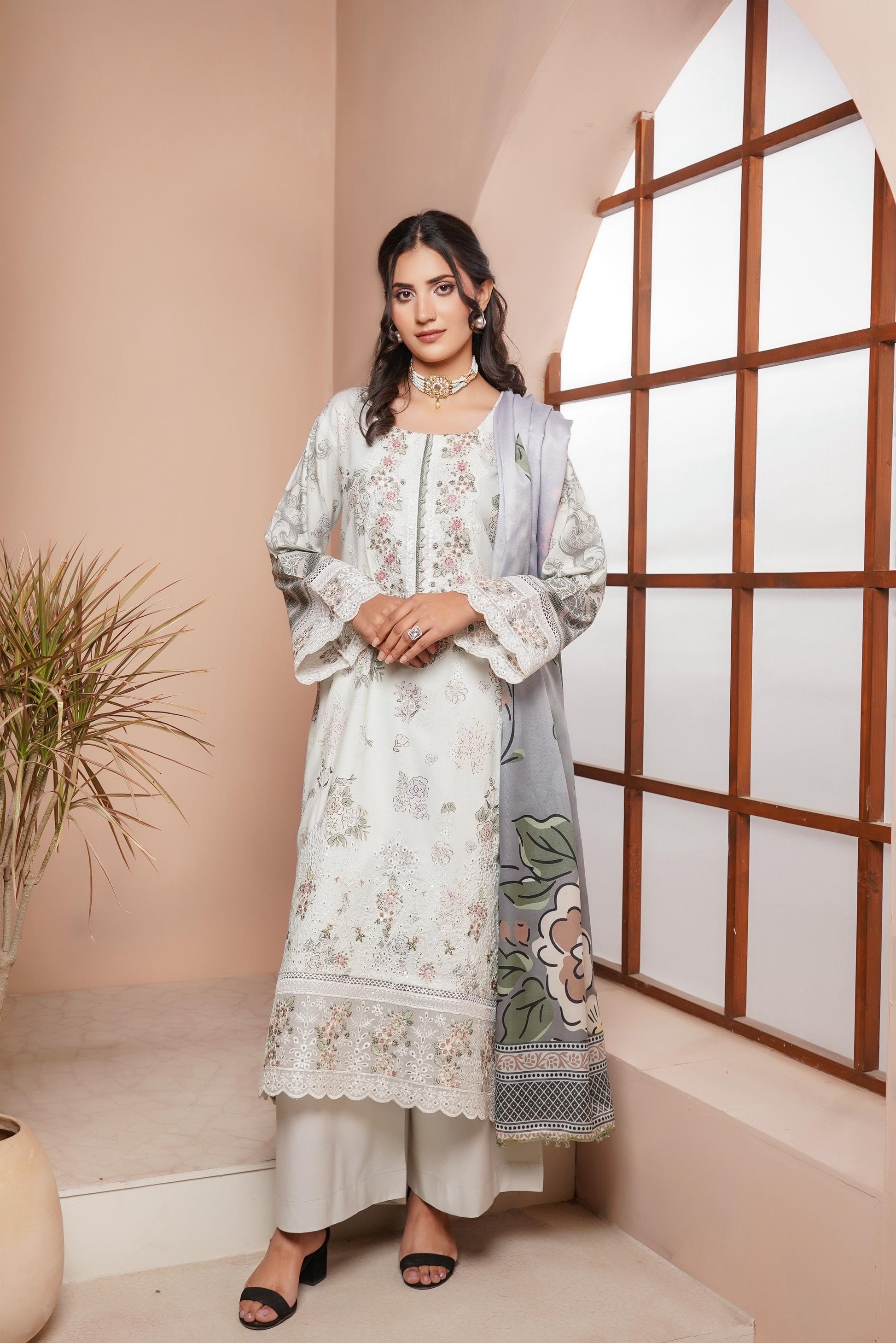 Traditional Pakistani Salwar Kameez for women in vibrant colors, with intricate embroidery and a matching dupatta.