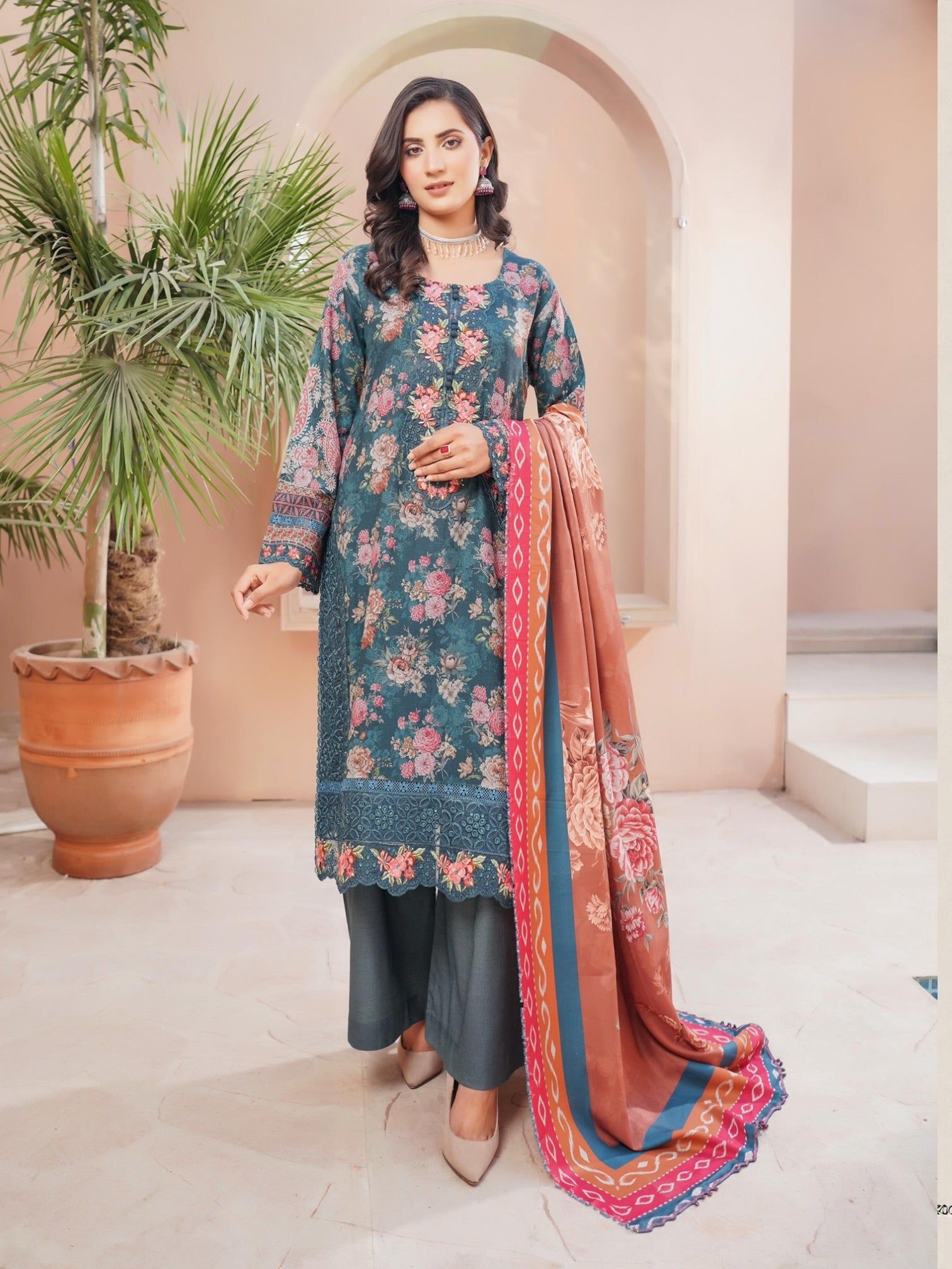 Traditional Pakistani Salwar Kameez by Saree Ghor Charlotte, vibrant cultural wear for women with intricate embroidery and colorful fabric.