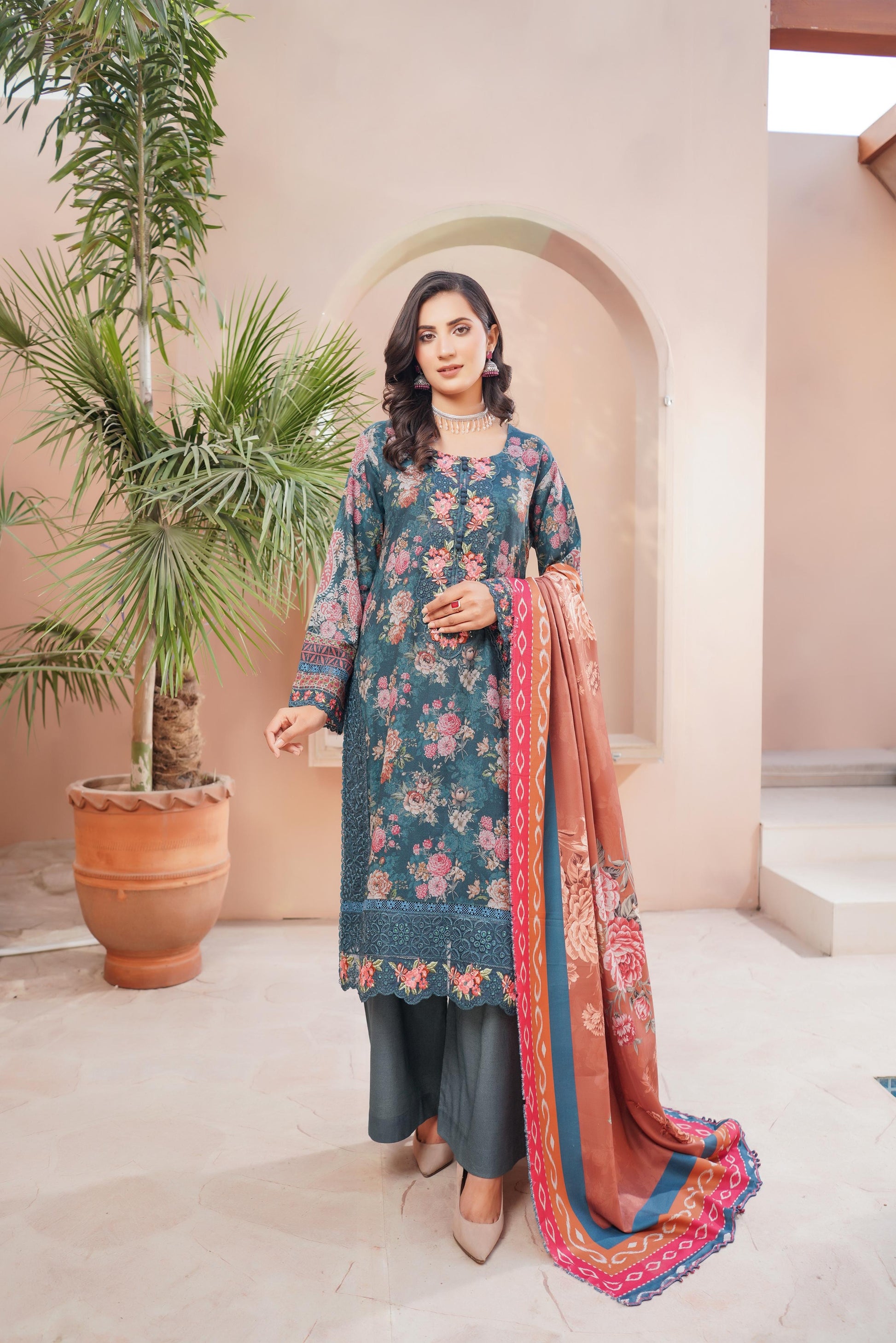 Traditional Pakistani Salwar Kameez for women, featuring vibrant cultural wear with intricate patterns and colorful fabric.