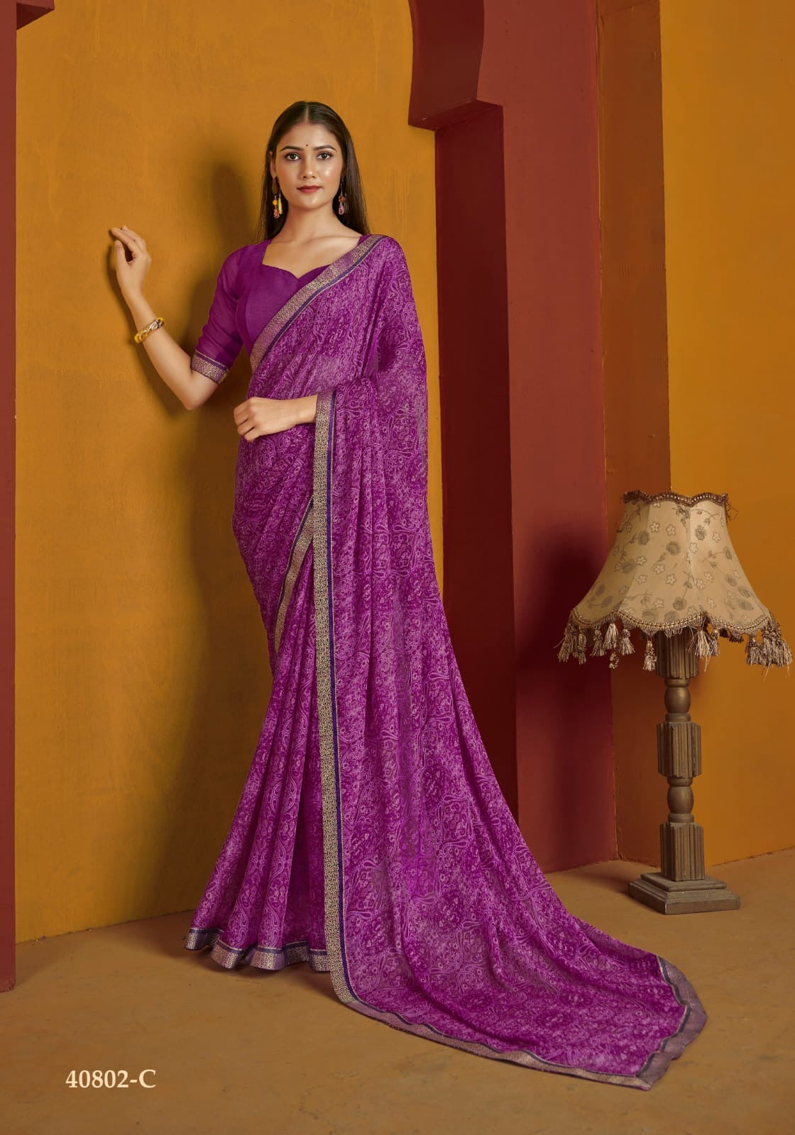 Traditional Saree by Saree Ghor Charlotte featuring intricate embroidery and vibrant colors, worn by a woman for cultural occasions.