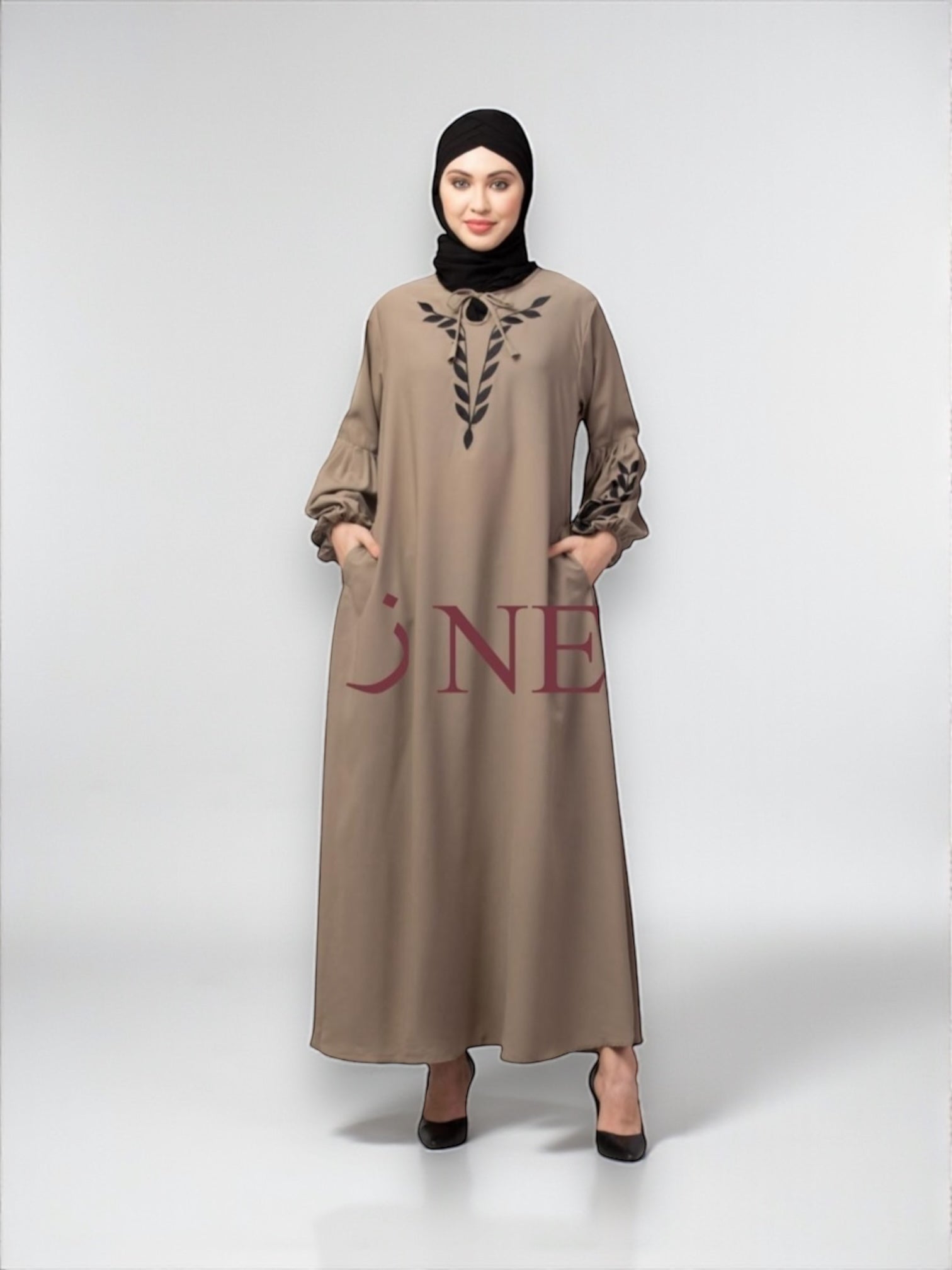 Women’s black Abaya Burqa by Saree Ghor Charlotte, modest Islamic dress with flowing fabric and intricate embroidery detail.