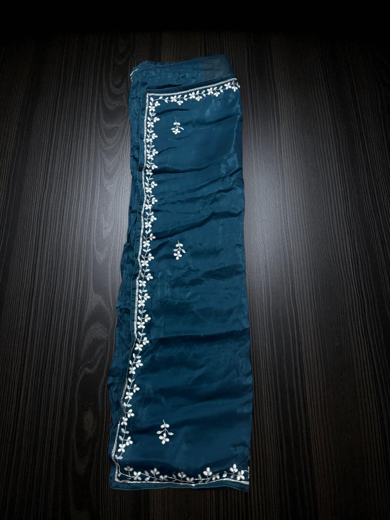 Elegant designer saree with ready blouse from Saree Ghor Charlotte, traditional cultural wear for women, detailed fabric pattern.