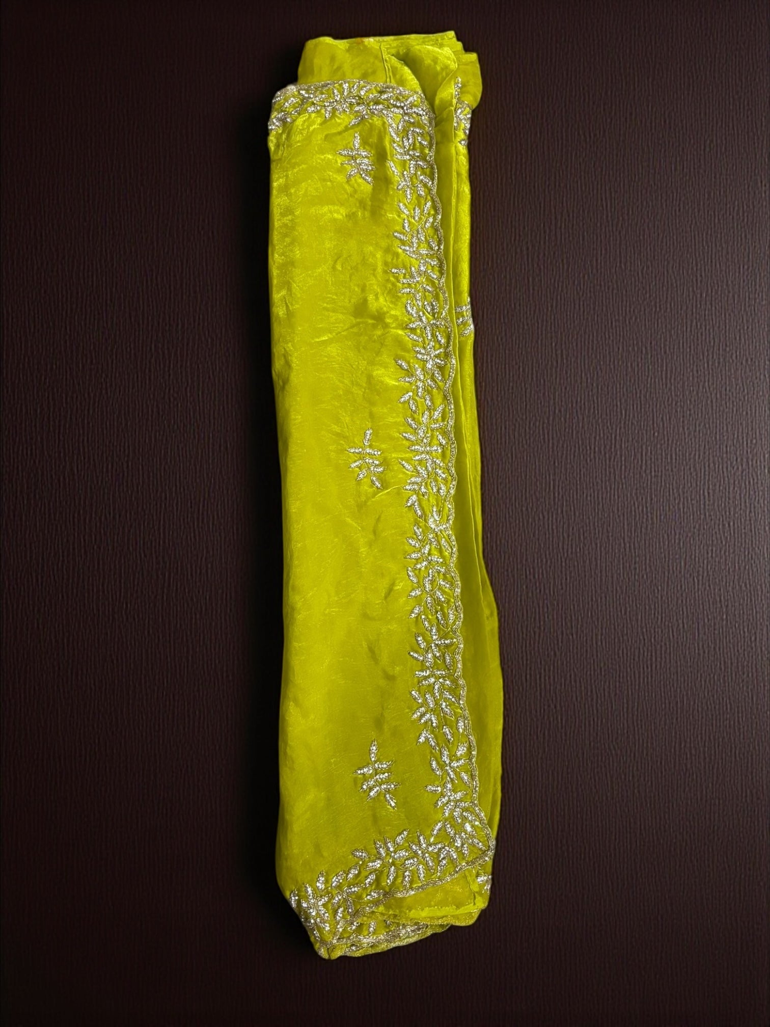 Elegant designer saree with matching ready blouse from Saree Ghor Charlotte, showcasing intricate traditional fabric and vibrant colors.