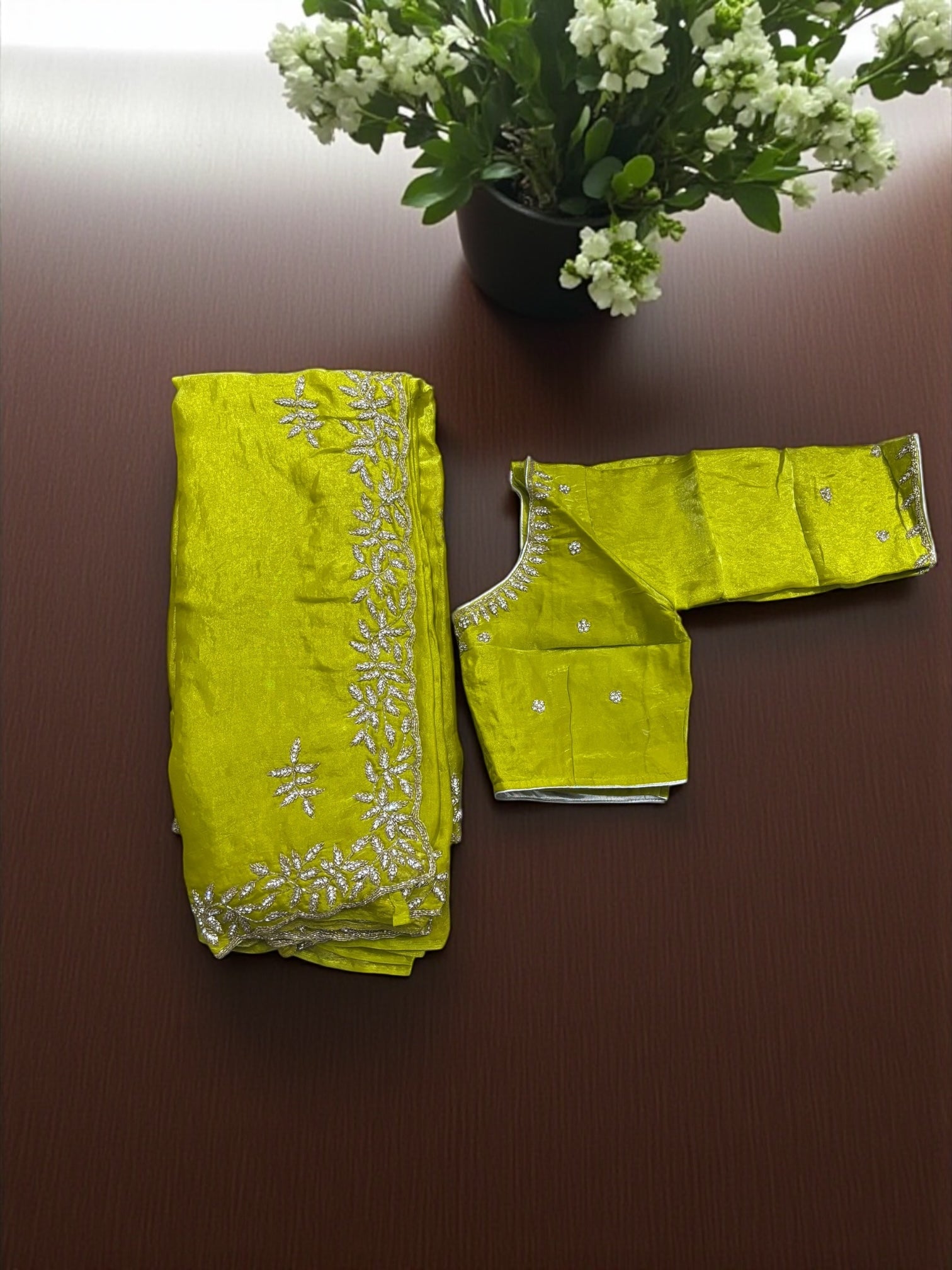 Elegant designer saree with ready blouse from Saree Ghor Charlotte, featuring intricate patterns and vibrant colors for cultural wear.