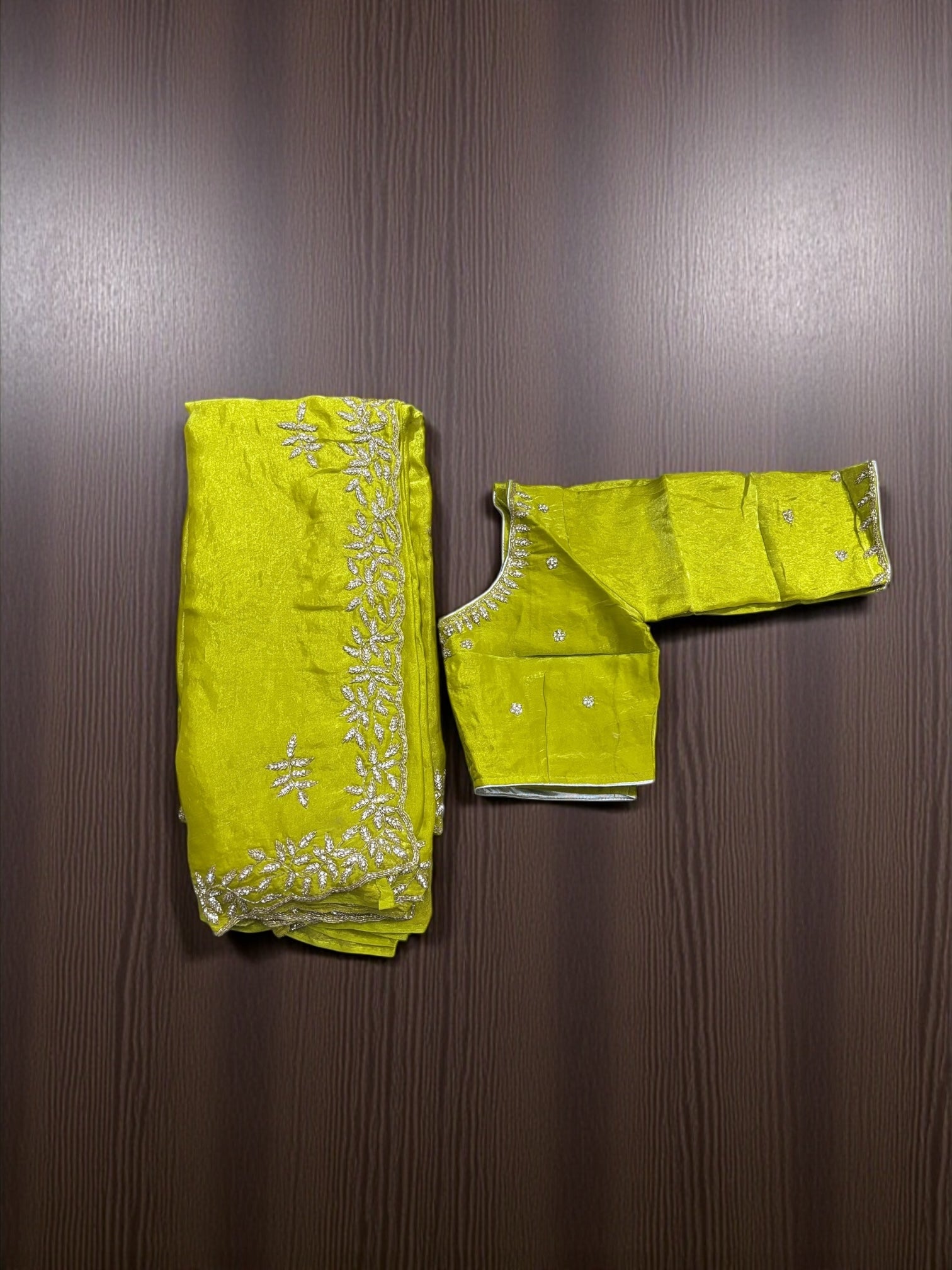 Elegant designer saree with ready blouse from Saree Ghor Charlotte, showcasing intricate fabric and traditional craftsmanship.