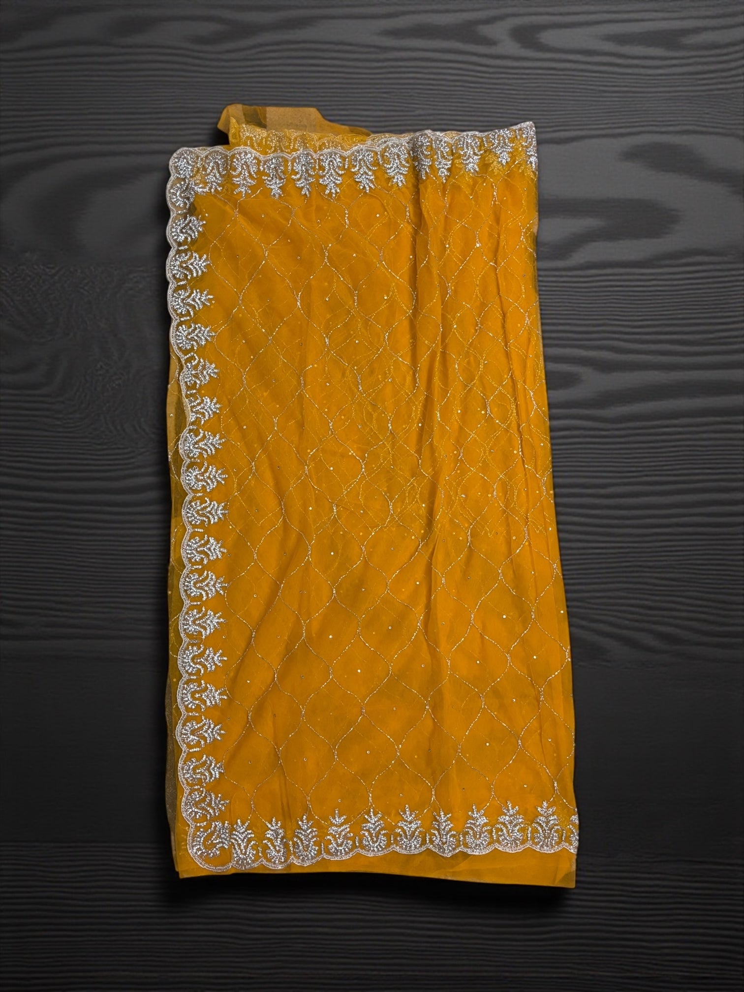 Elegant designer net saree with matching ready blouse, cultural wear for women by Saree Ghor Charlotte, shown with intricate draping.