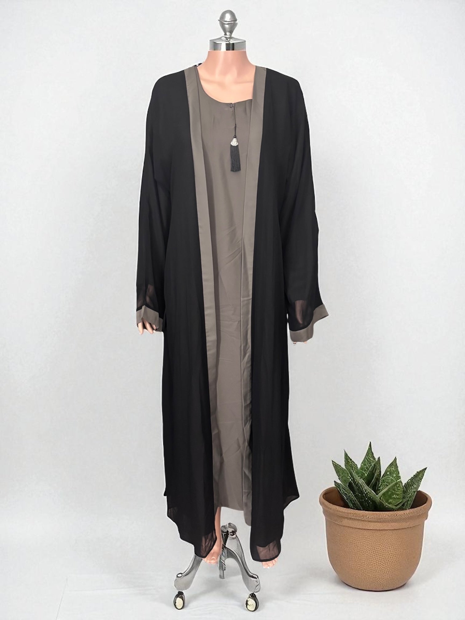Women’s black Abaya burqa by Saree Ghor Charlotte, modest Islamic dress with flowing fabric and elegant design.