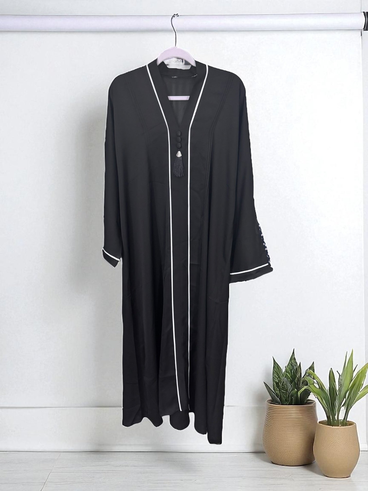Women’s black Abaya Burqa by Saree Ghor Charlotte, modest Islamic dress with flowing fabric and elegant design.