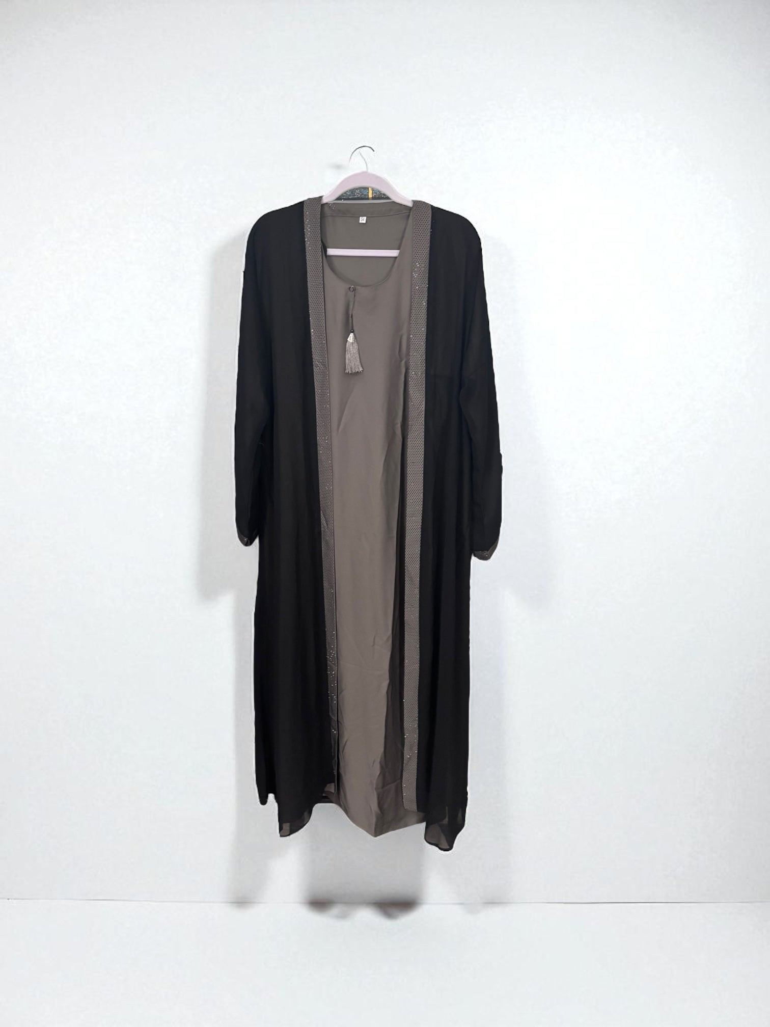 Women’s black Abaya Burqa by Saree Ghor Charlotte, modest Islamic dress with flowing fabric and intricate detailing, front view.