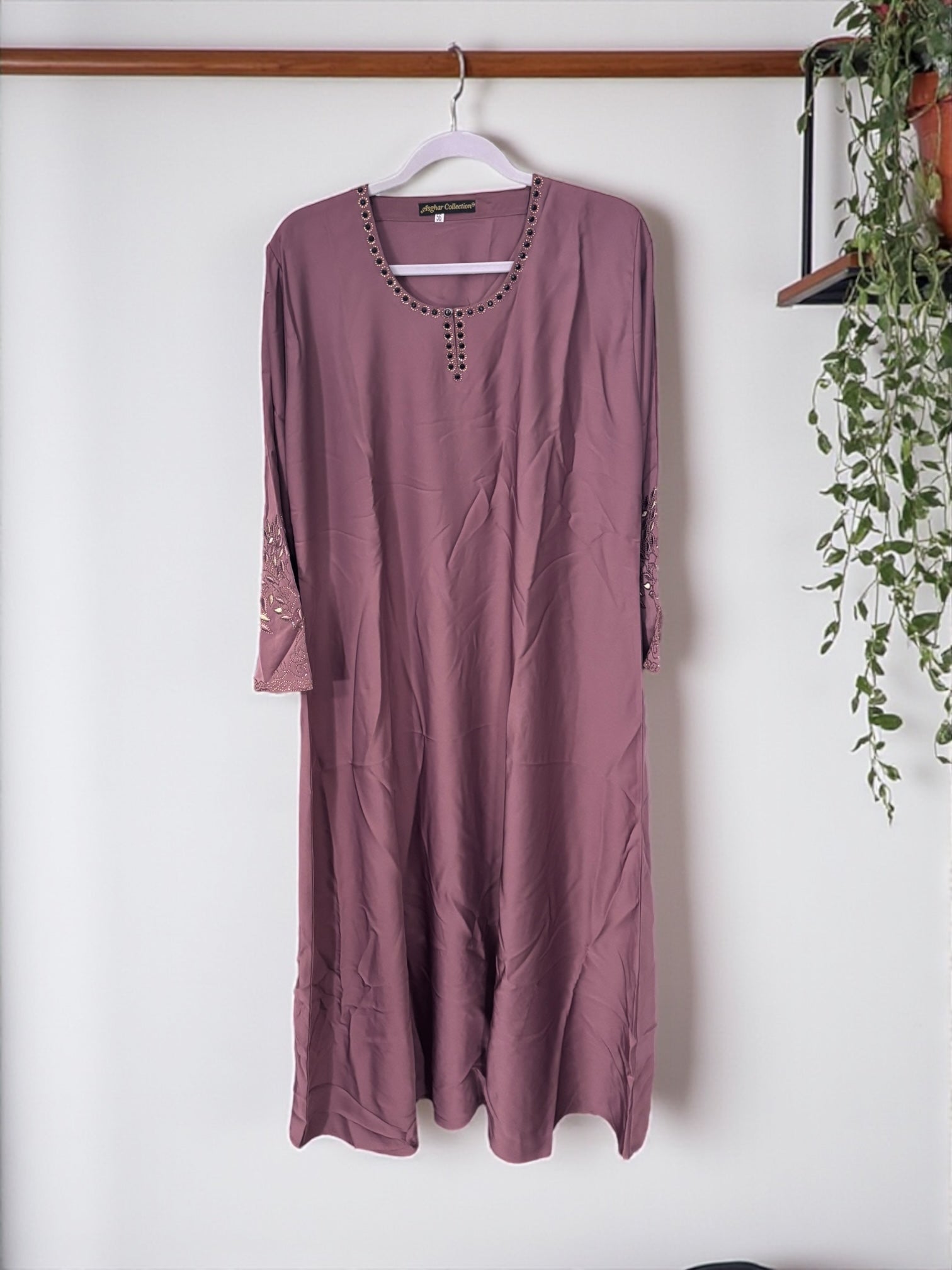 Women’s black abaya burqa by Saree Ghor Charlotte, modest Islamic dress with flowing fabric and elegant design, shown on a model.