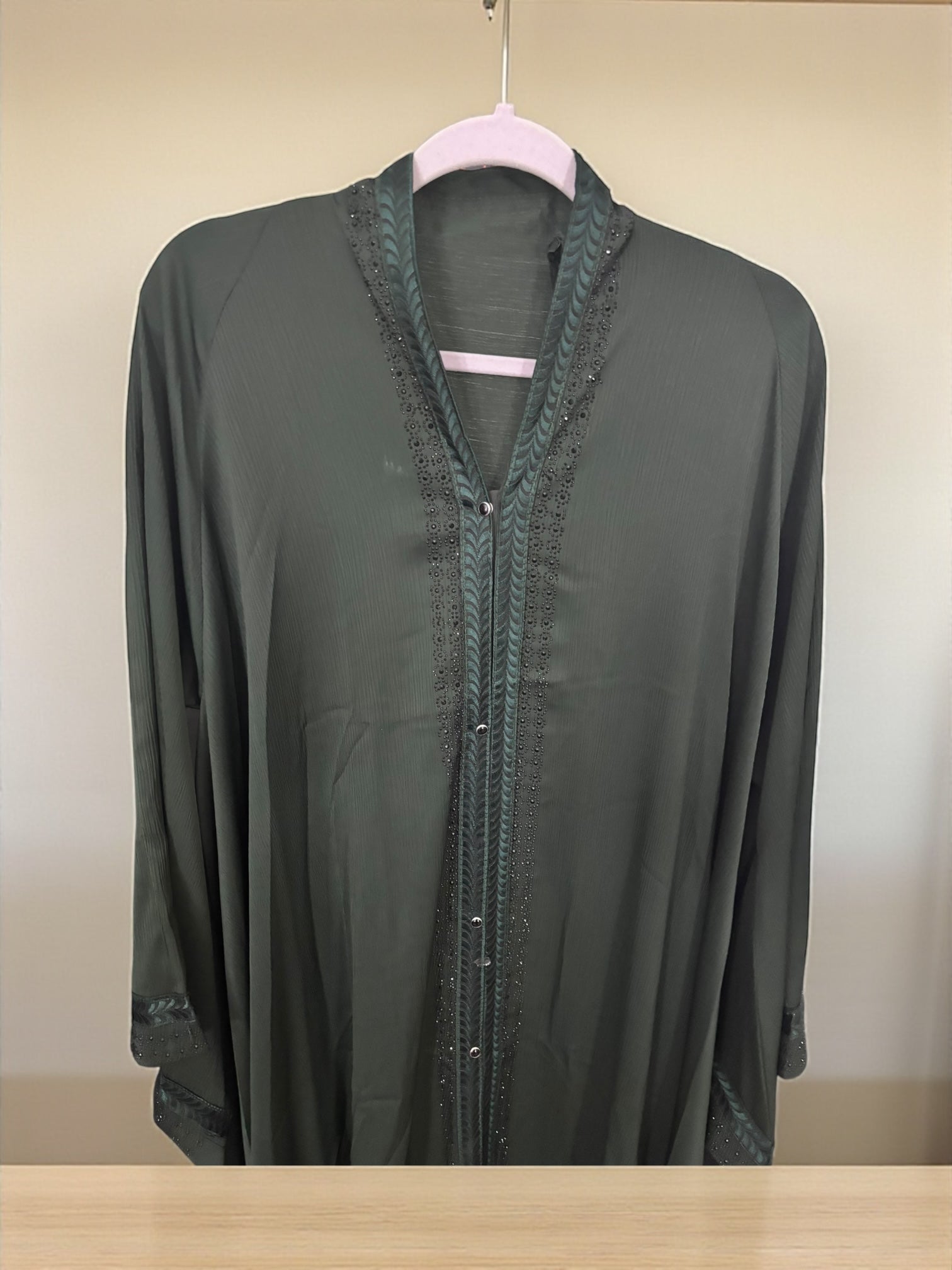 Women’s black Abaya Burqa by Saree Ghor Charlotte, modest Islamic dress with flowing fabric and elegant design, front view.