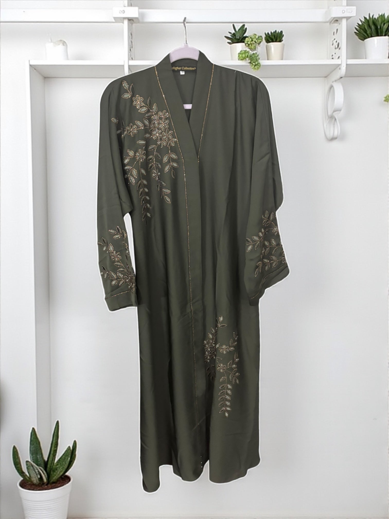 Women’s black abaya burqa by Saree Ghor Charlotte, modest Islamic dress with intricate embroidery and flowing fabric.