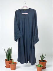 Women’s black Abaya Burqa by Saree Ghor Charlotte, modest Islamic dress with flowing fabric and full-length coverage.