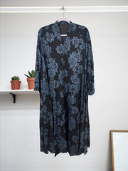 Women’s black Abaya burqa by Saree Ghor Charlotte, modest Islamic dress with flowing fabric and elegant design, front view.