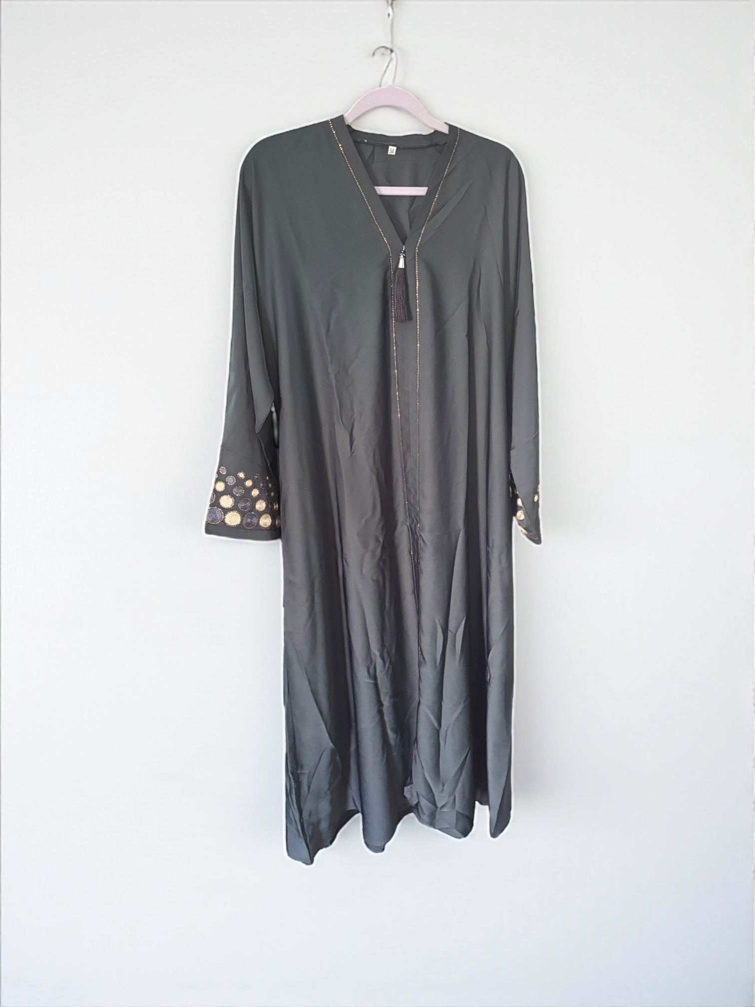 Green women's Abaya Burqa by Saree Ghor Charlotte, modest Islamic dress with flowing fabric and full coverage, suitable for religious attire.