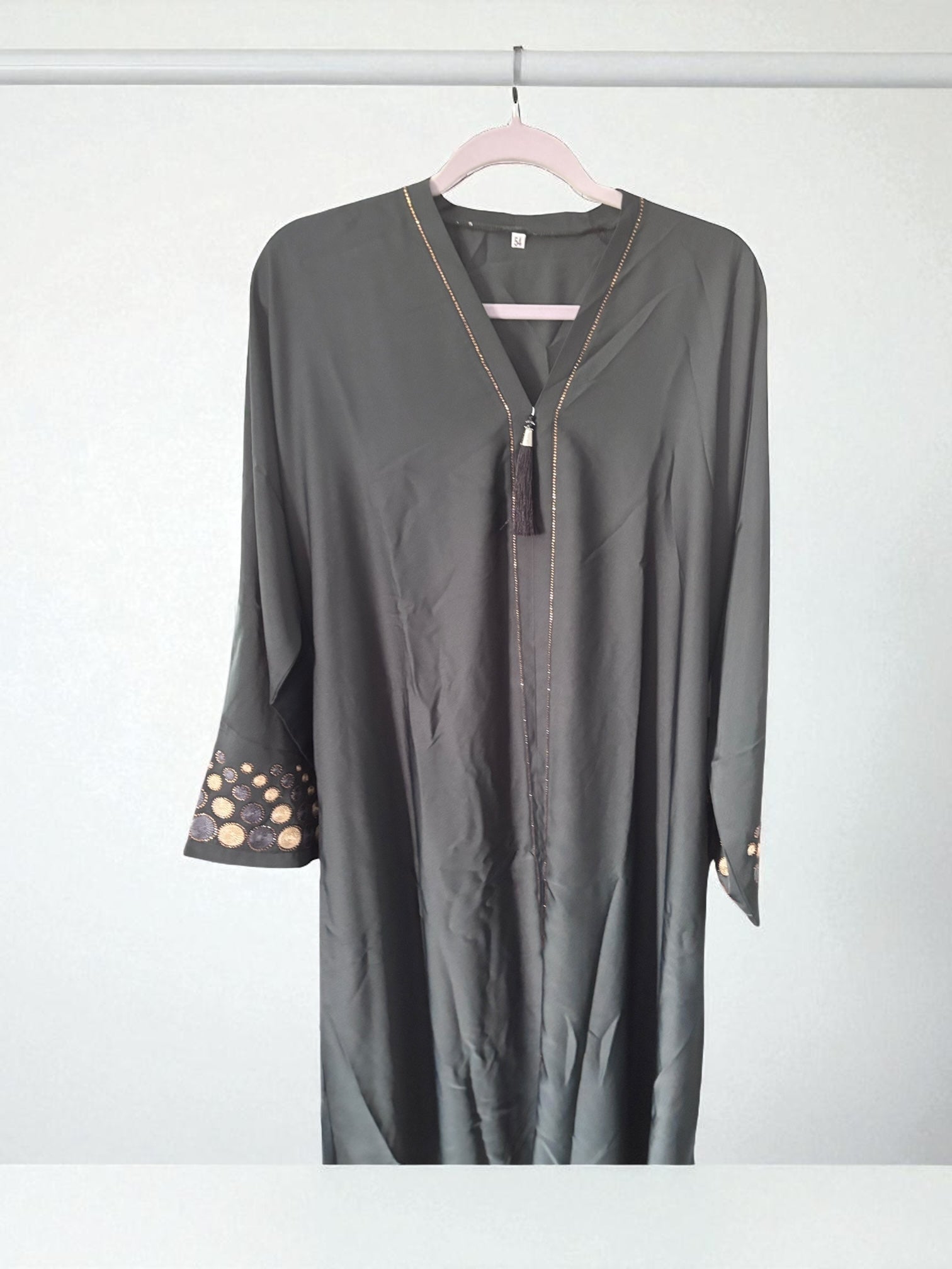 Green women's abaya by Saree Ghor Charlotte, modest Islamic dress with flowing fabric and elegant design.