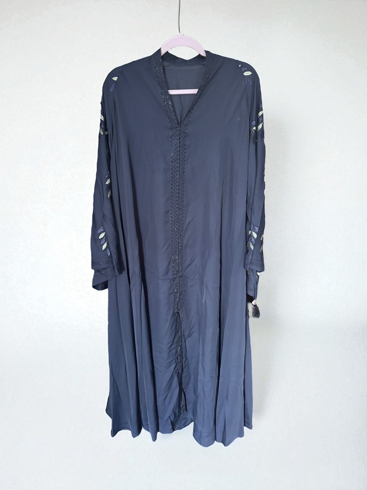 Women’s blue abaya burqa by Saree Ghor Charlotte, modest Islamic dress with flowing fabric and traditional design.