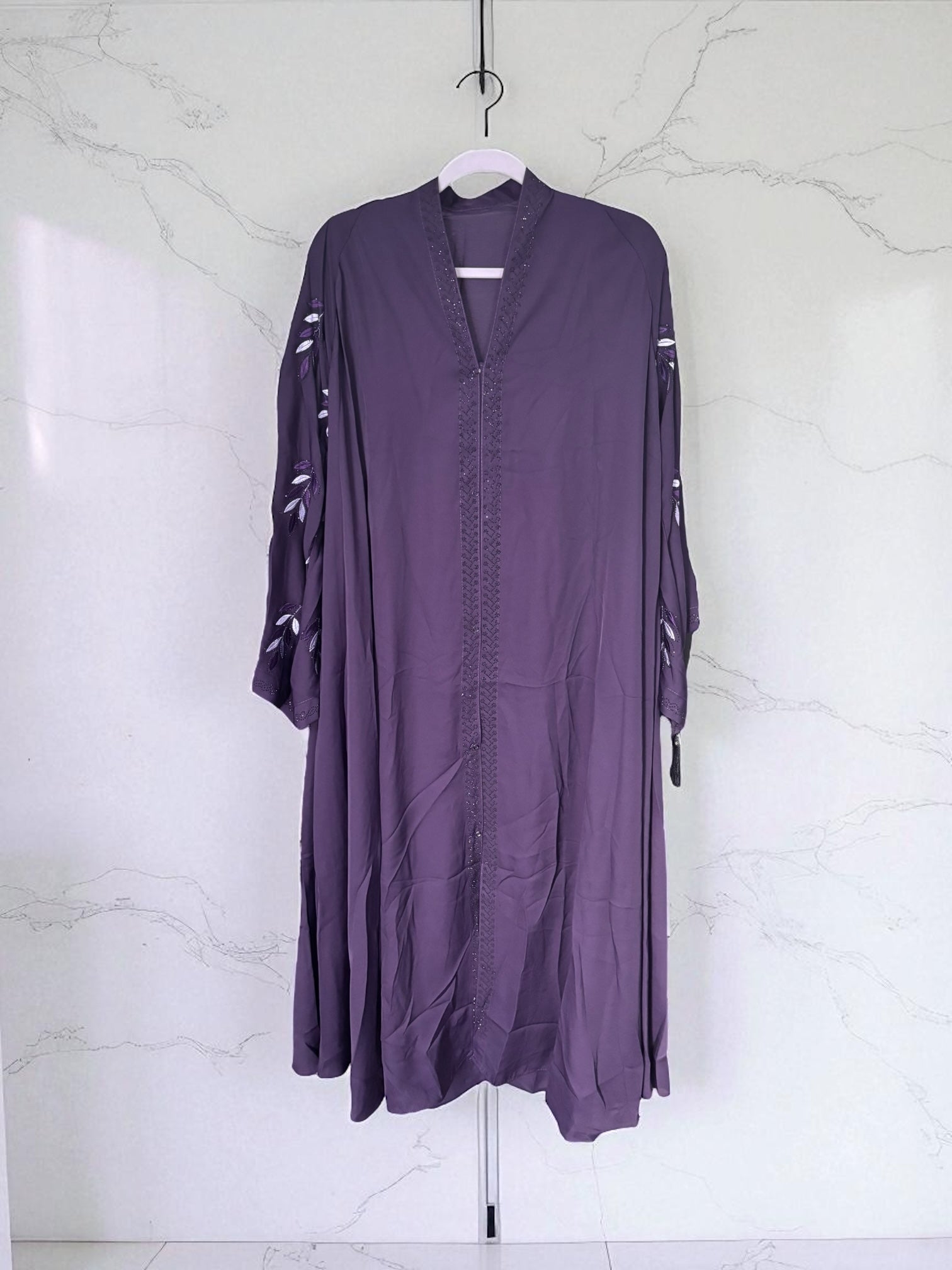 Women’s black Abaya Burqa by Saree Ghor Charlotte, modest Islamic dress with full-length flowing fabric and intricate details.