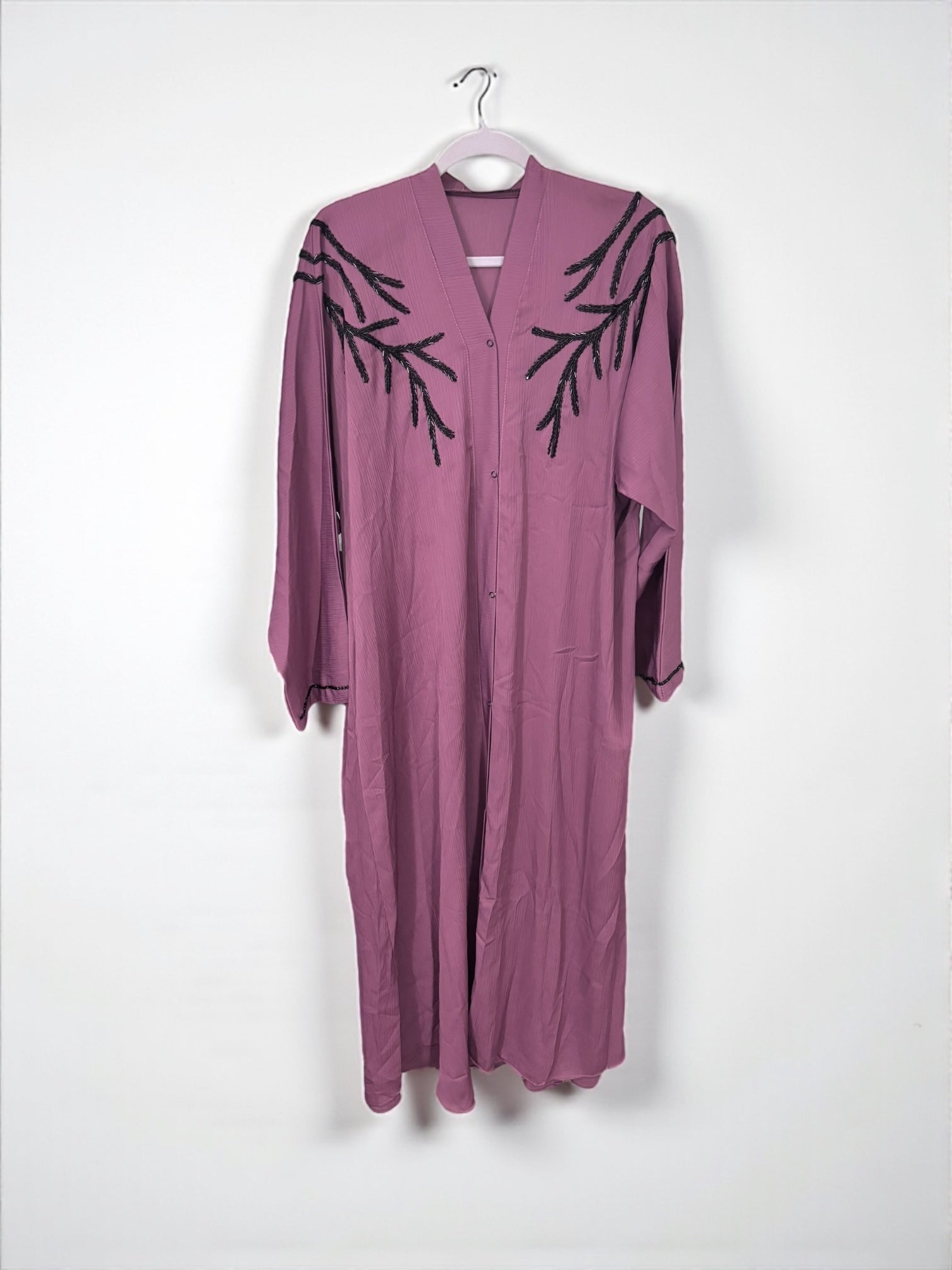 Women’s black Abaya burqa by Saree Ghor Charlotte, modest Islamic dress with flowing fabric and elegant design.