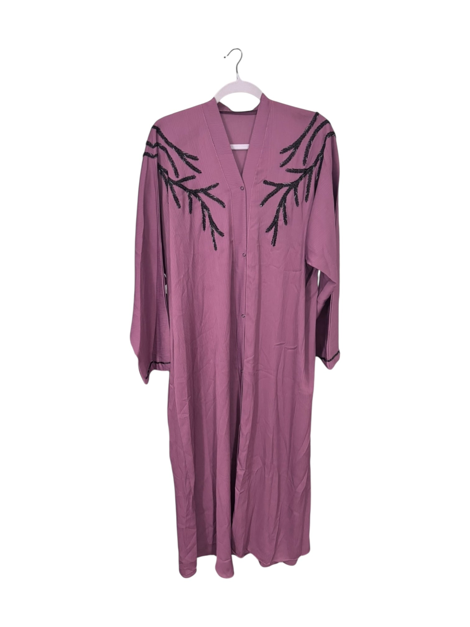 Women’s black Abaya Burqa by Saree Ghor Charlotte, modest Islamic dress with elegant design, worn by a woman.