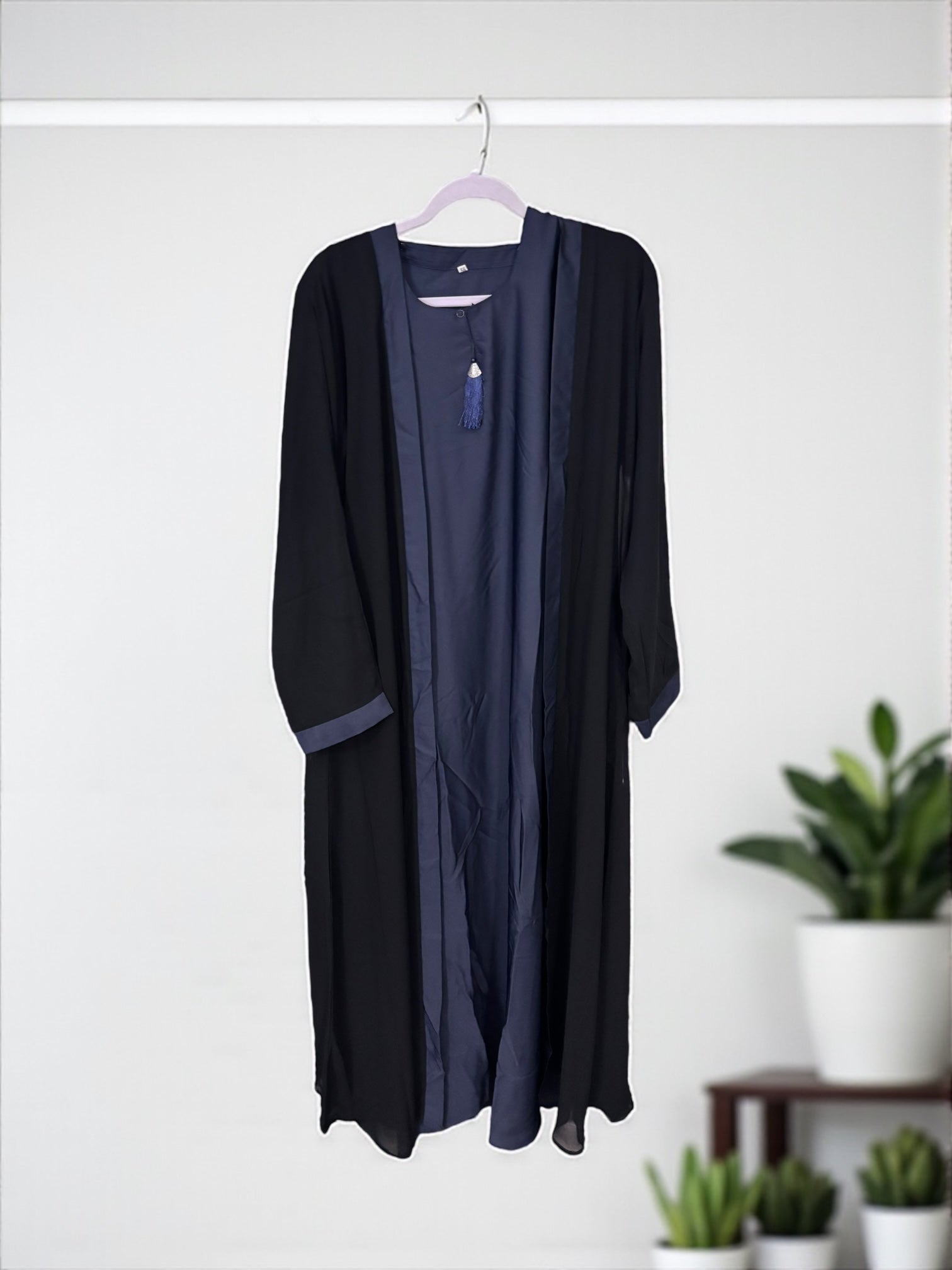 Women’s black Abaya burqa by Saree Ghor Charlotte, modest Islamic dress with flowing fabric and full-length coverage.
