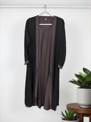 Women’s black Abaya Burqa by Saree Ghor Charlotte, modest Islamic dress with flowing fabric and elegant design.