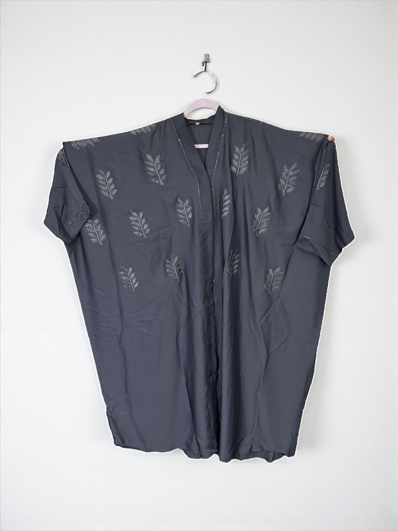 Women’s black kaftan abaya by Saree Ghor Charlotte, modest Islamic dress with flowing fabric and elegant design, front view.