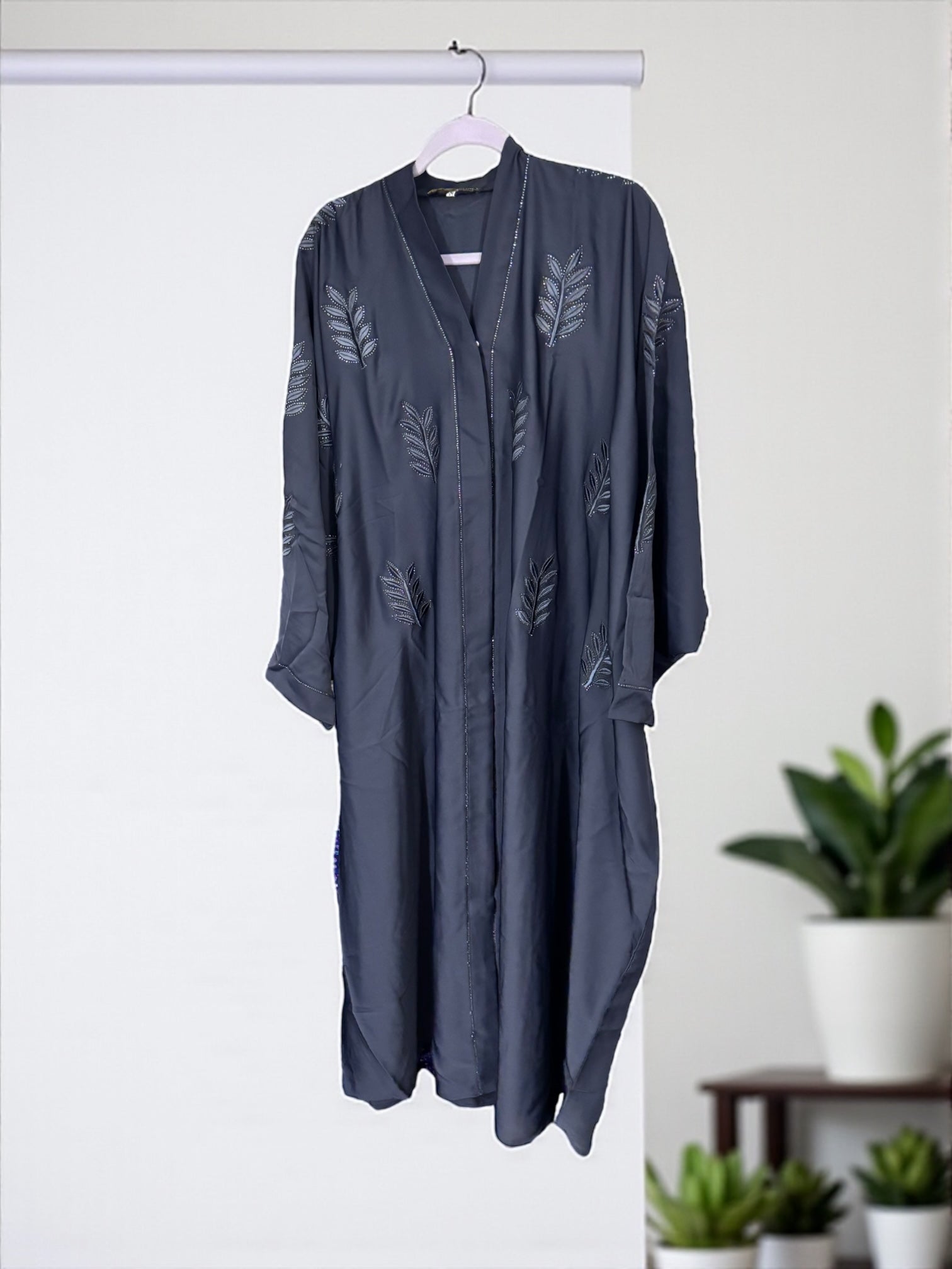 Women’s black kaftan abaya by Saree Ghor Charlotte featuring modest Islamic dress with intricate embroidery and flowing fabric.