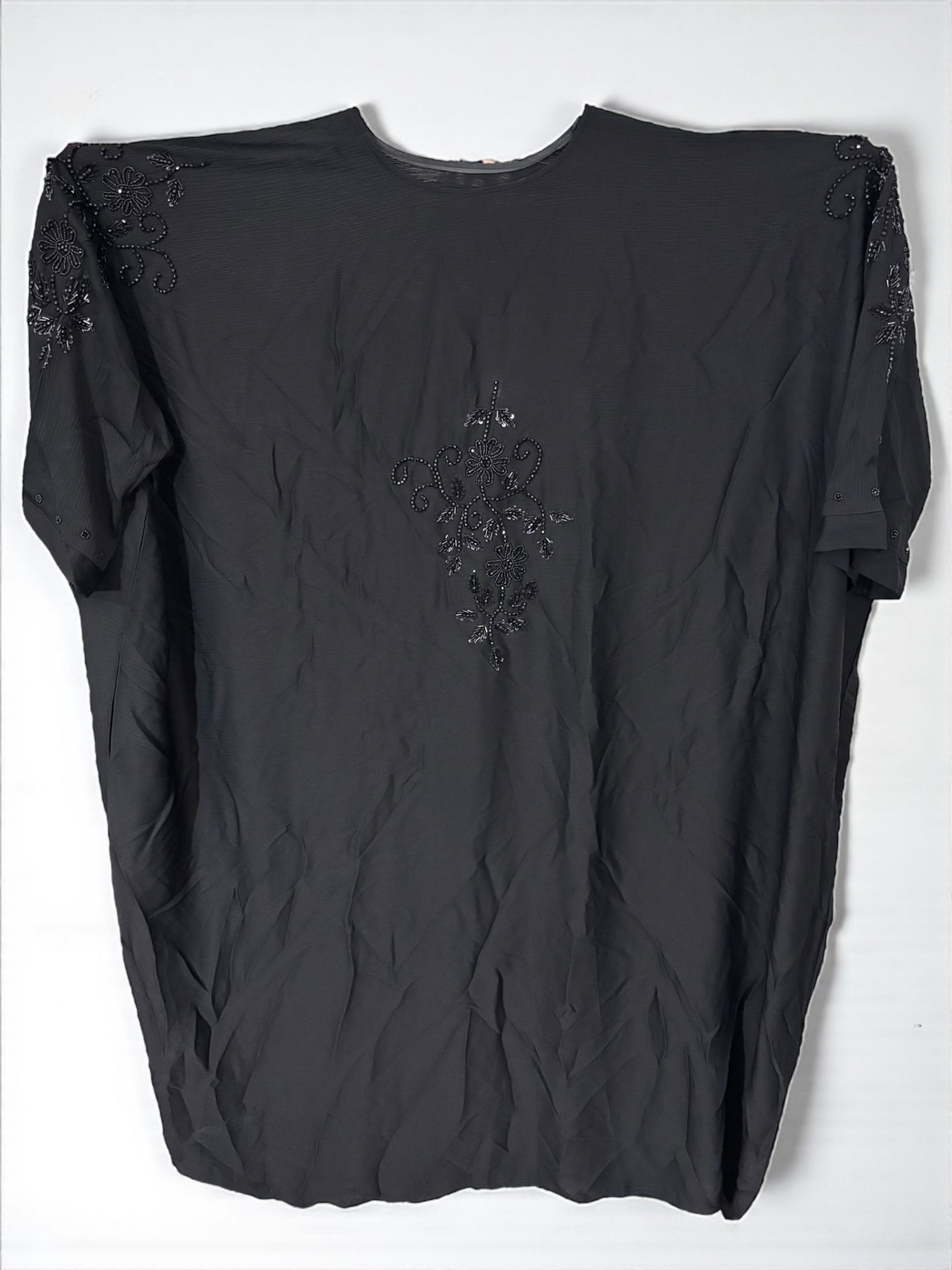 Women’s black kaftan abaya by Saree Ghor Charlotte, modest Islamic dress with flowing fabric and elegant design.