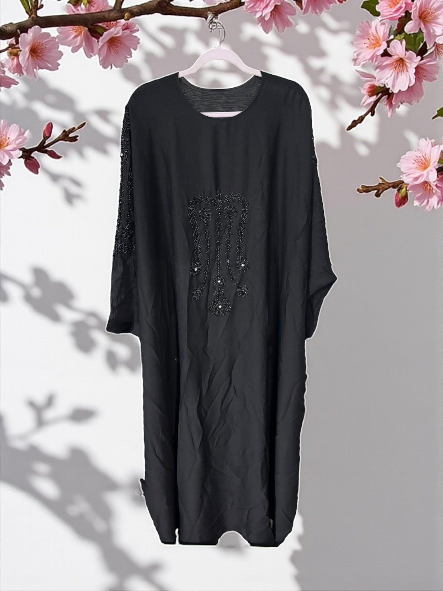 Women’s black kaftan abaya by Saree Ghor Charlotte, modest Islamic dress with flowing fabric and elegant design.