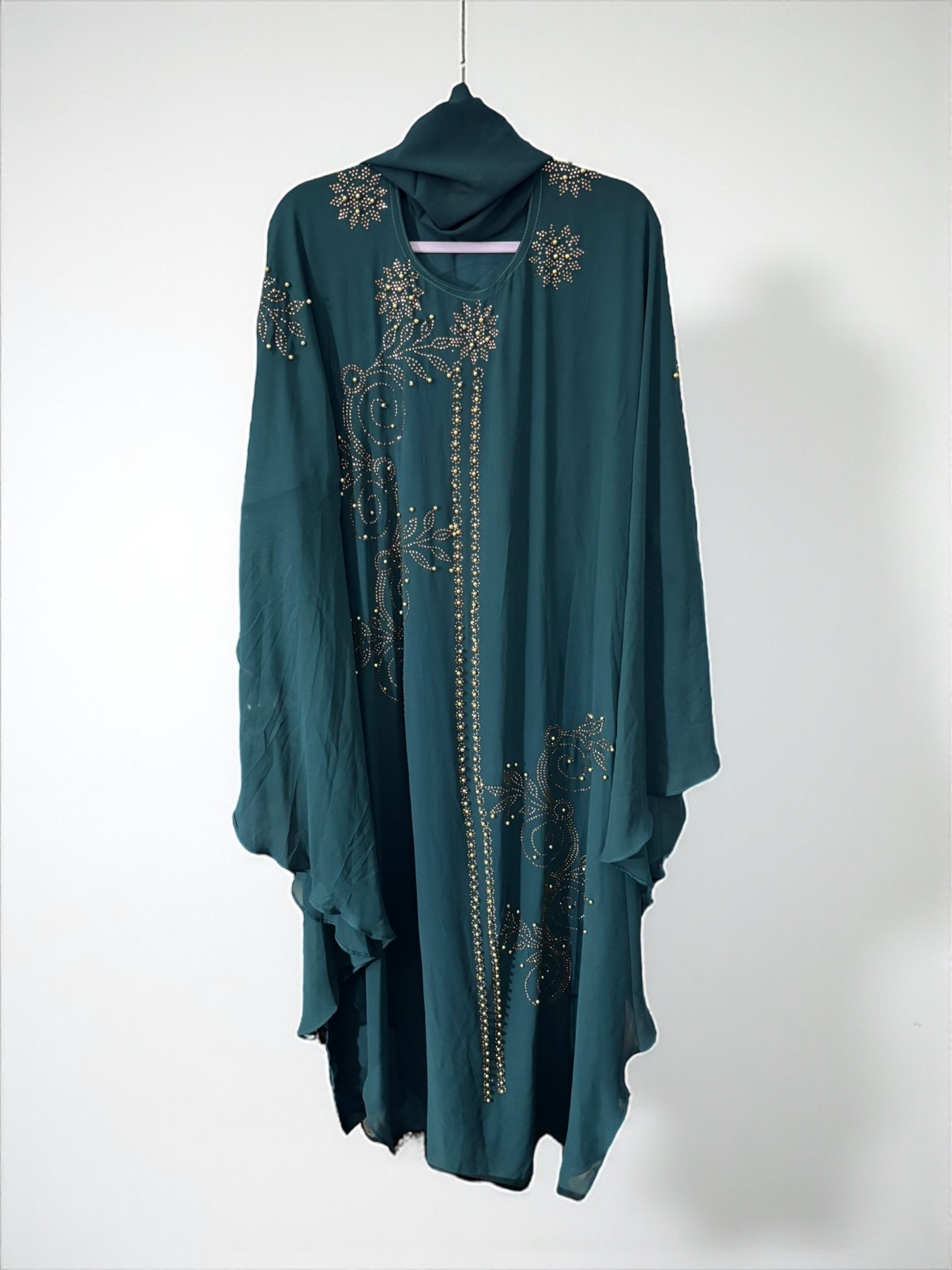 Women’s beige kaftan abaya by Saree Ghor Charlotte, modest Islamic dress with flowing fabric and elegant design.