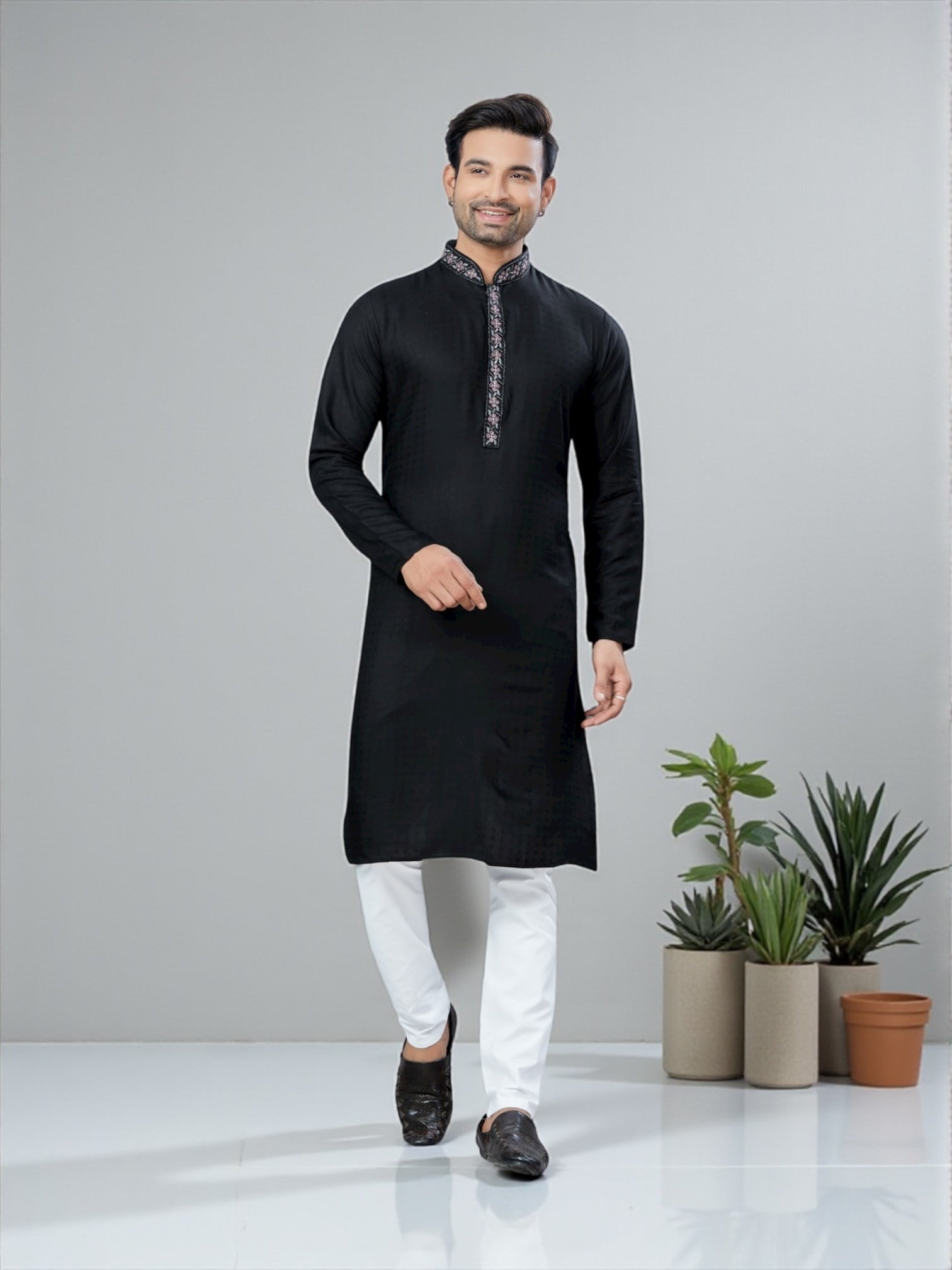 Black men's traditional kurta and pajama set by Saree Ghor Charlotte, showcasing cultural men's wear with intricate design details.