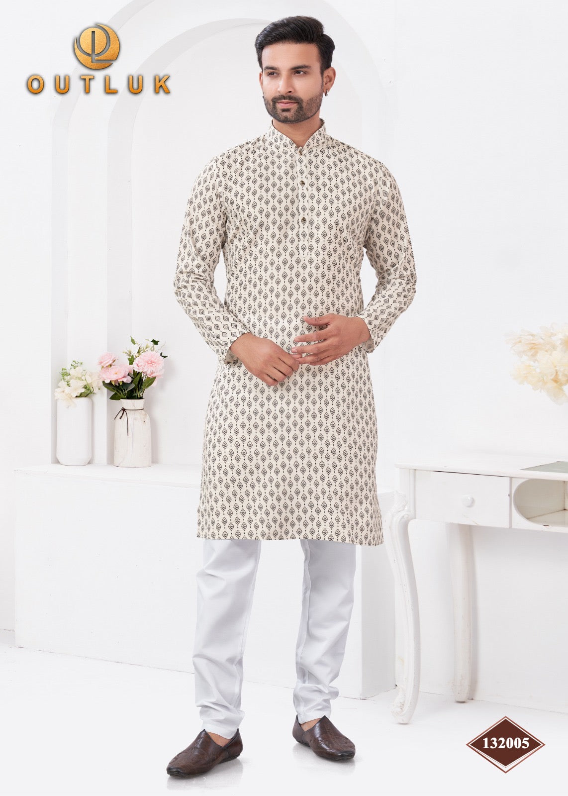 White traditional men's kurta and pajama set by Saree Ghor Charlotte, showcasing cultural wear with intricate design details.