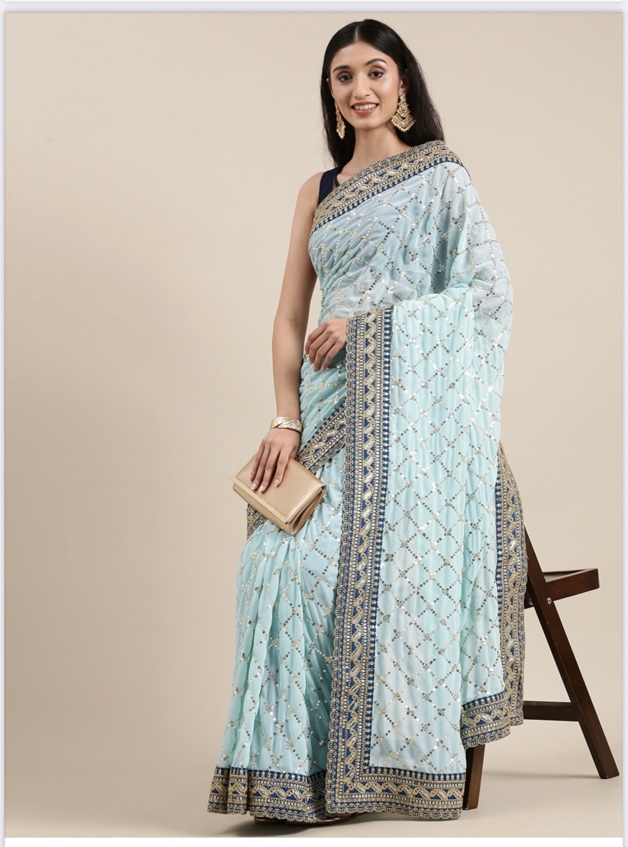 Elegant georgette traditional saree for women by Saree Ghor Charlotte, showcasing intricate draping and vibrant cultural design.