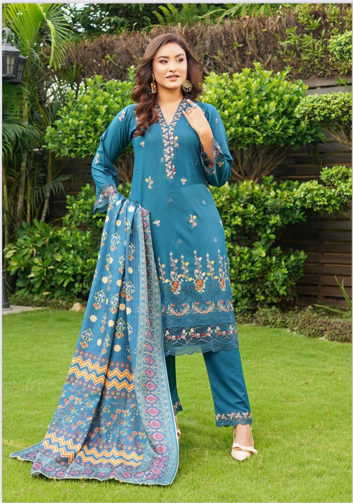 Traditional Pakistani Salwar Kameez for women by Saree Ghor Charlotte, featuring colorful fabric and intricate embroidery.