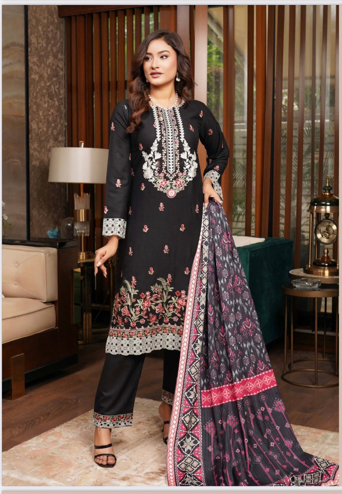 Traditional Pakistani Salwar Kameez for women by Saree Ghor Charlotte, featuring colorful fabric and intricate embroidery.