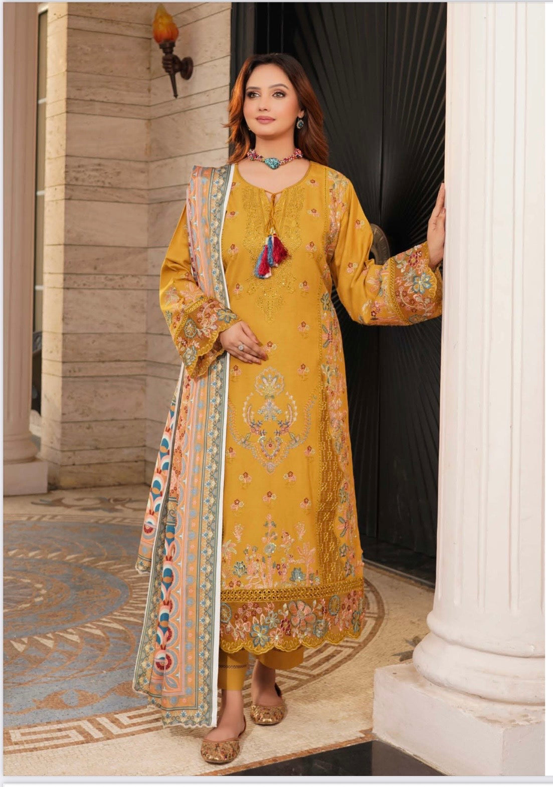 Traditional Pakistani Salwar Kameez for women by Saree Ghor Charlotte, featuring colorful fabric and intricate embroidery.