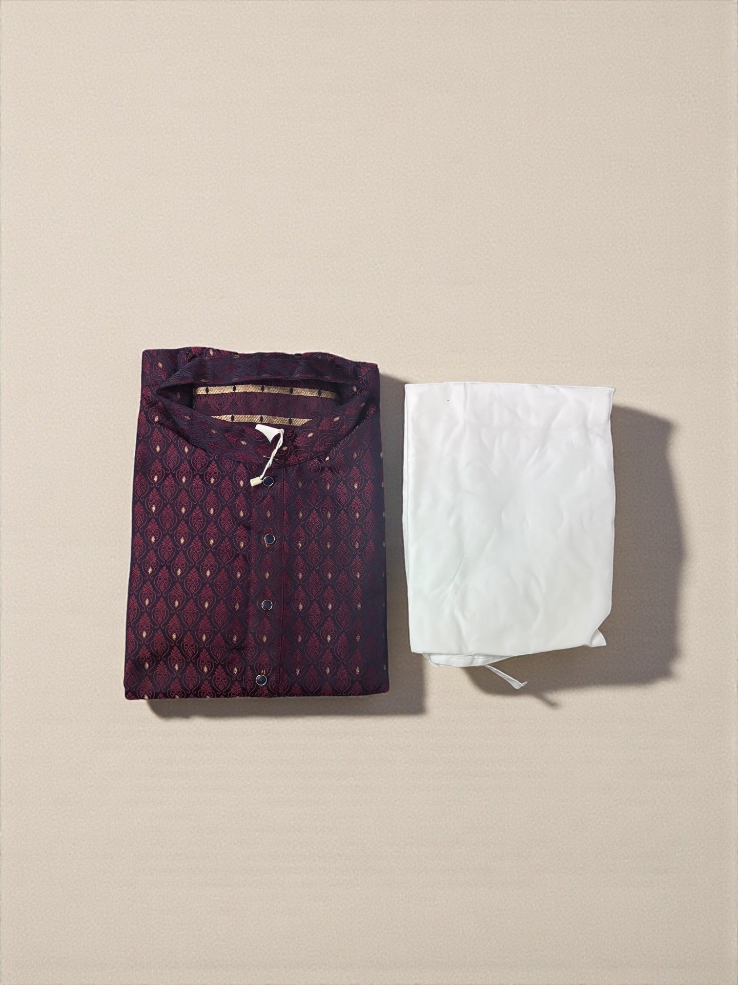 Maroon traditional men's kurta and pajama set from Saree Ghor Charlotte, showcasing cultural wear with intricate design details.