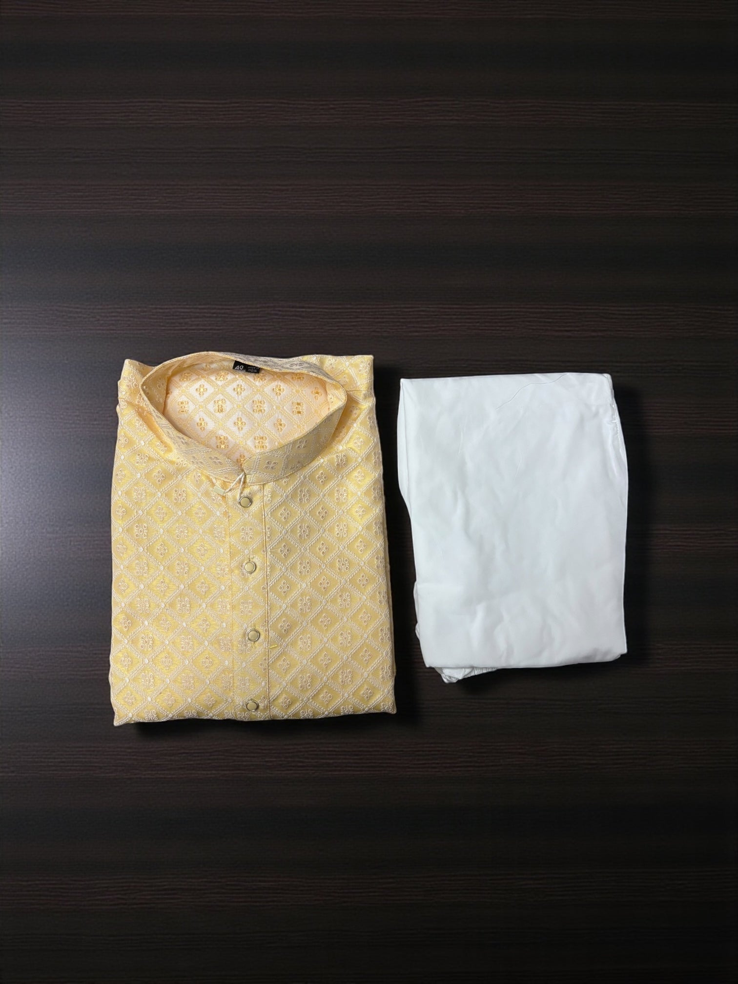 Yellow traditional men's kurta pajama set displayed, showcasing intricate design and cultural wear by Saree Ghor Charlotte.