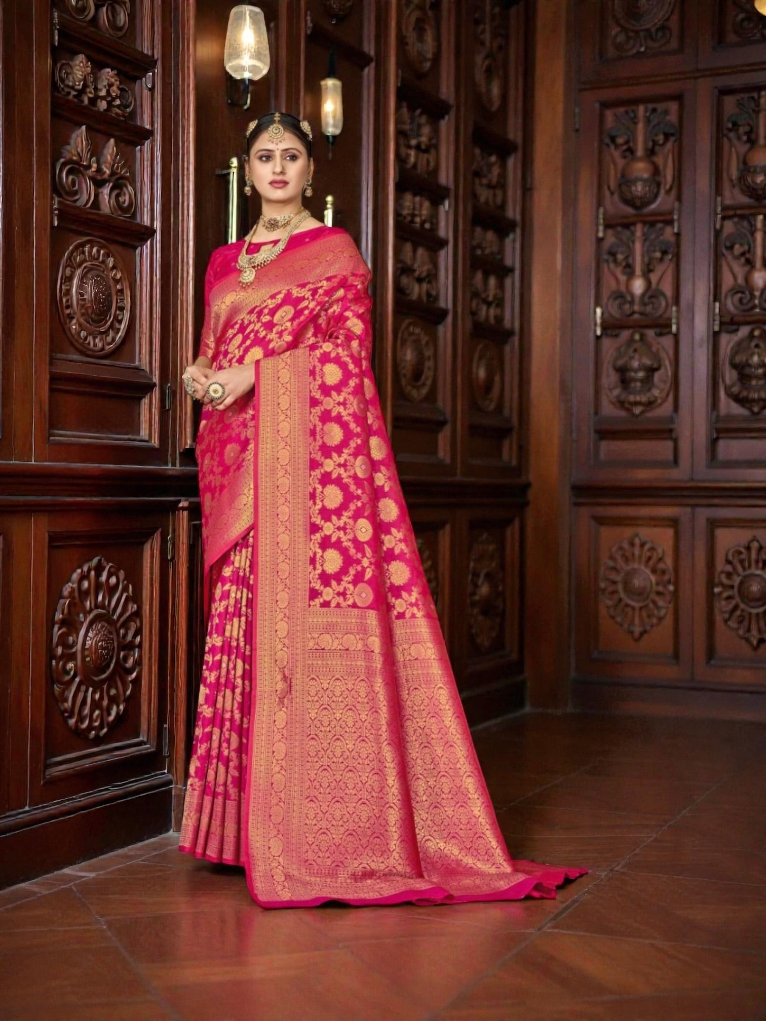 Katan Silk Traditional Saree in rich colors, draped elegantly on a mannequin, showcasing intricate patterns and texture.