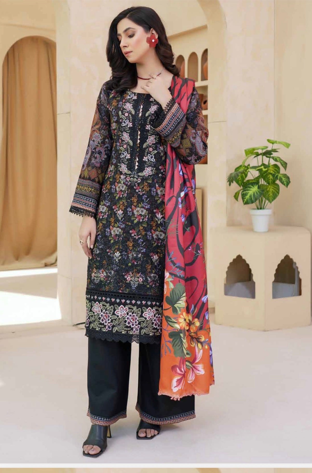 Traditional Pakistani Salwar Kameez by Saree Ghor Charlotte, featuring vibrant embroidery and elegant cultural attire for women.