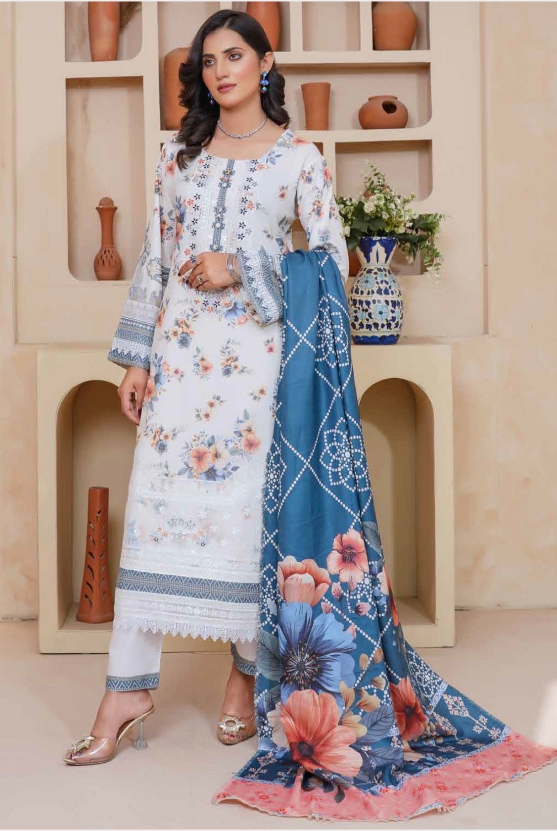 Traditional Pakistani Salwar Kameez by Saree Ghor Charlotte featuring colorful embroidery and lightweight fabric for cultural wear.