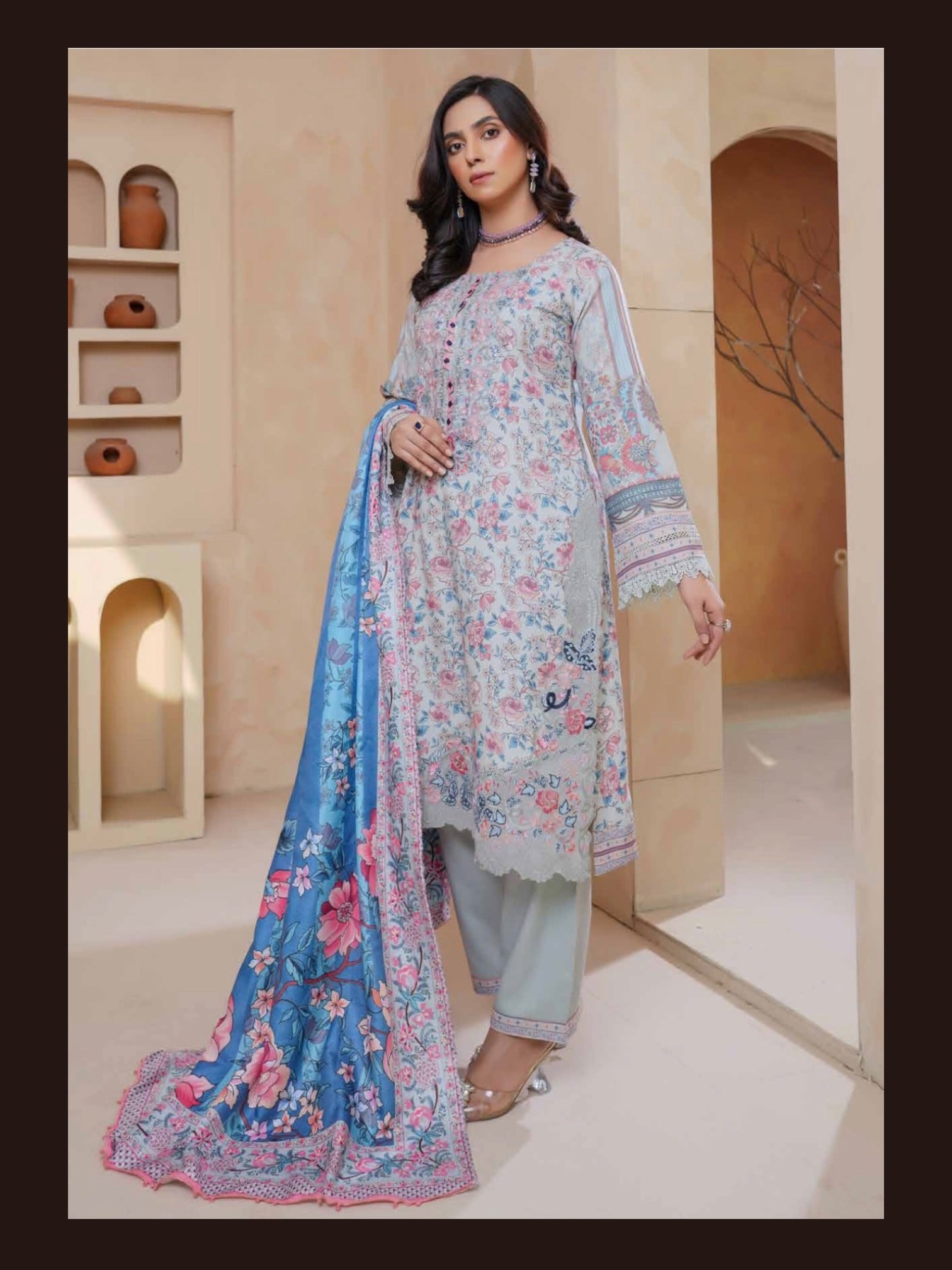 Traditional Pakistani Salwar Kameez in vibrant colors, featuring intricate embroidery, worn by a woman showcasing cultural wear.