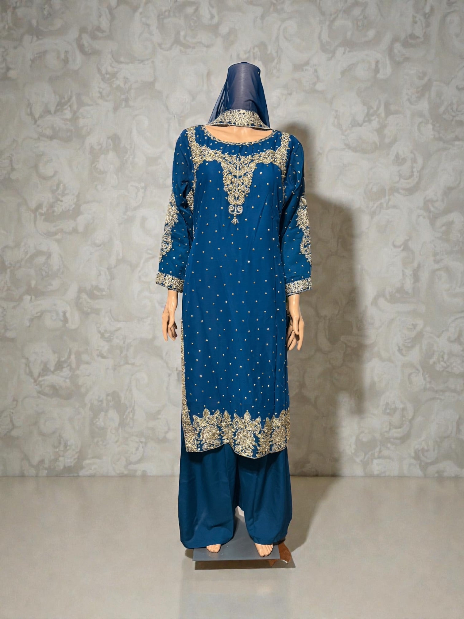 Traditional Salwar Kameez for women from Saree Ghor Charlotte, showcasing vibrant fabric and intricate embroidery.