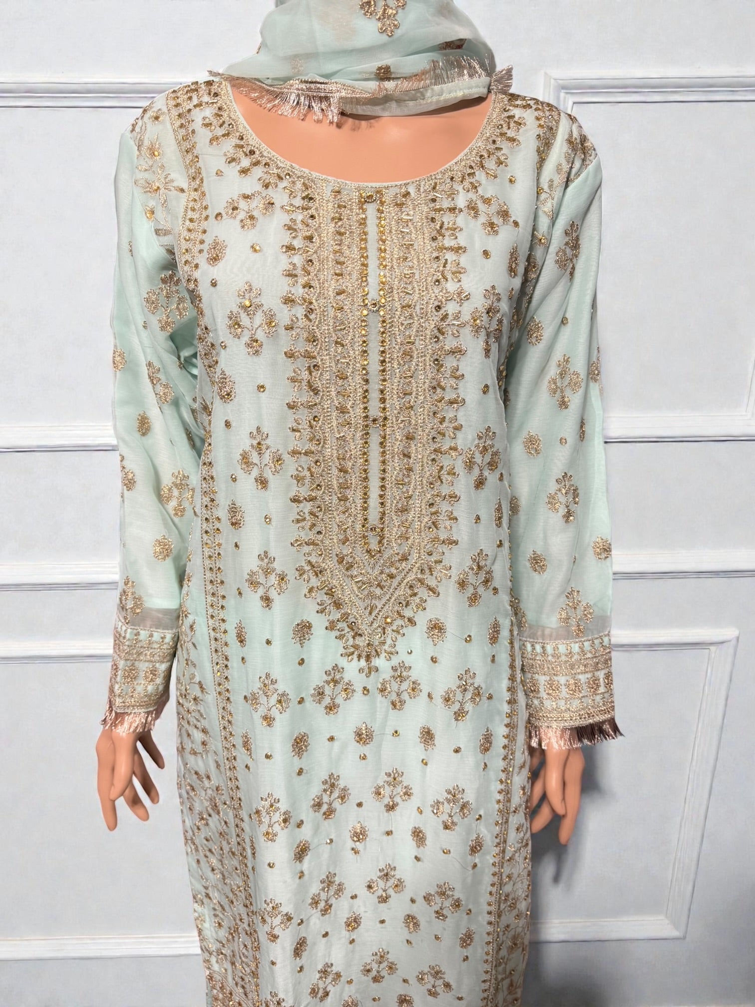 Traditional Salwar Kameez for women by Saree Ghor Charlotte, featuring vibrant fabric and intricate embroidery.
