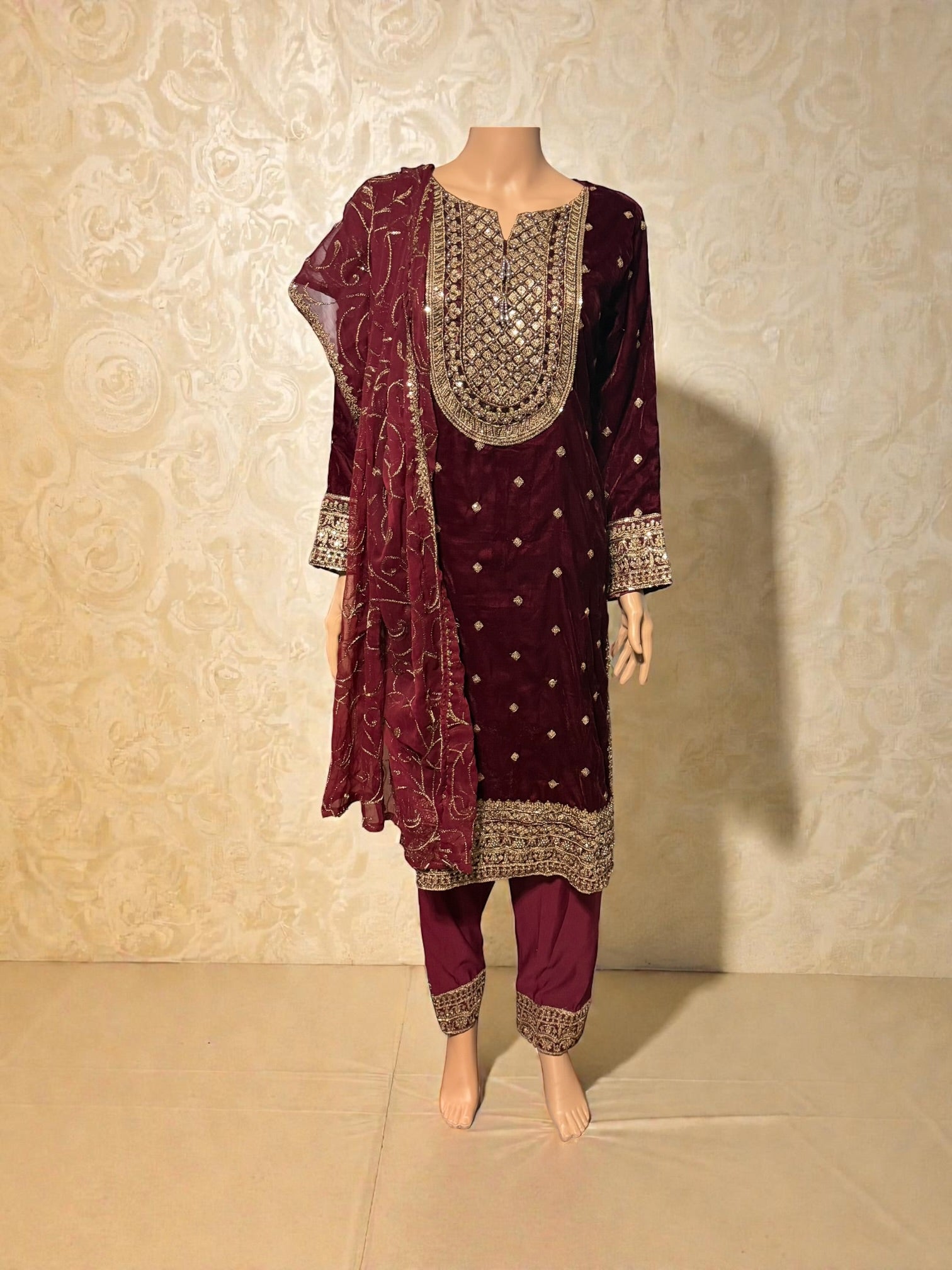 Traditional salwar kameez for women by Saree Ghor Charlotte, featuring intricate patterns and vibrant colors.