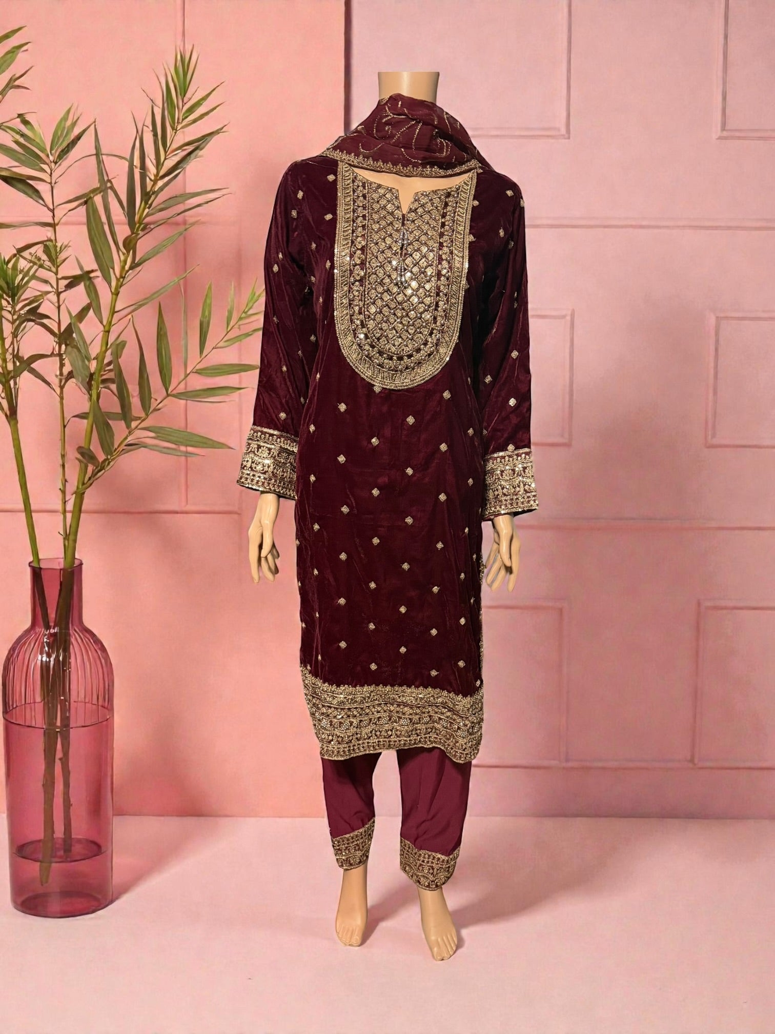 Traditional women's Salwar Kameez in vibrant colors by Saree Ghor Charlotte, showcasing intricate patterns and fabric texture.