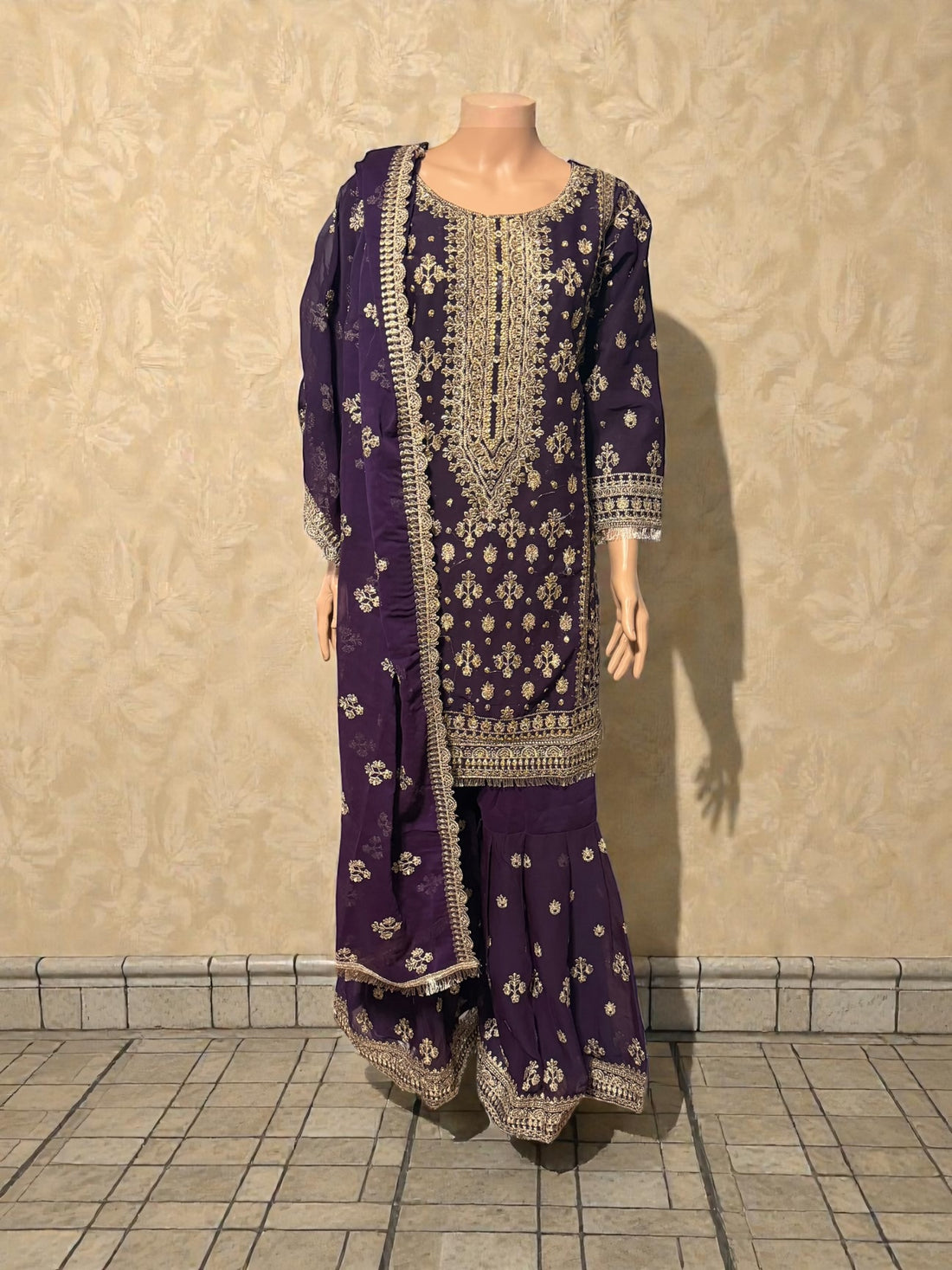 Traditional Salwar Kameez for women by Saree Ghor Charlotte, featuring vibrant fabric and intricate embroidery.