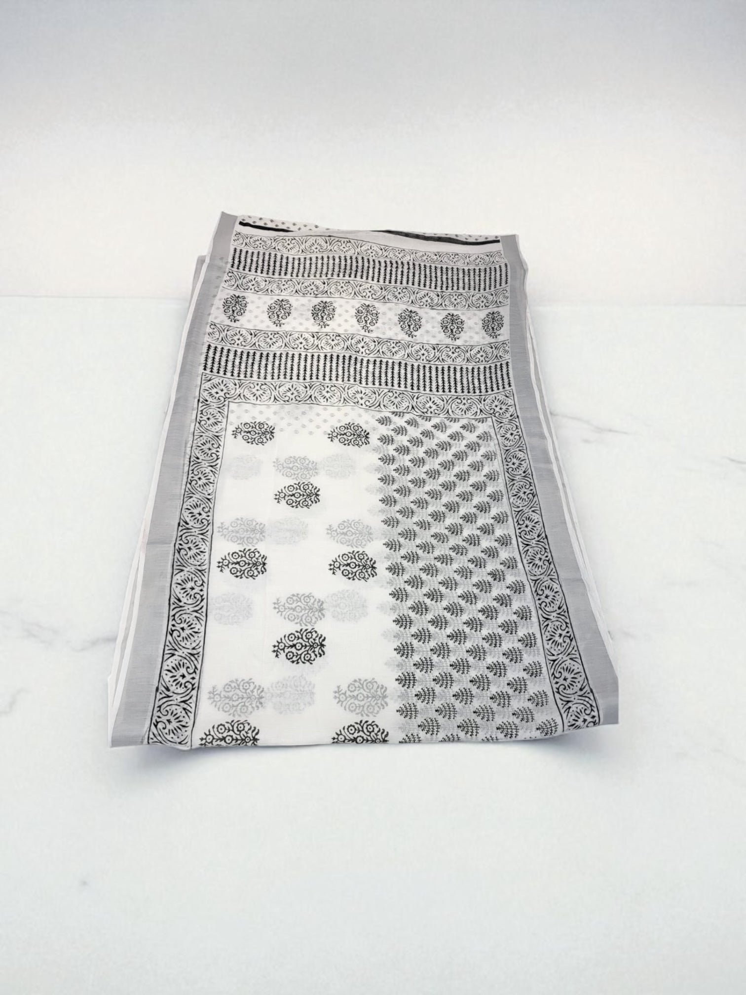 Traditional soft linen print saree by Saree Ghor Charlotte, featuring intricate cultural design and elegant draping for women.